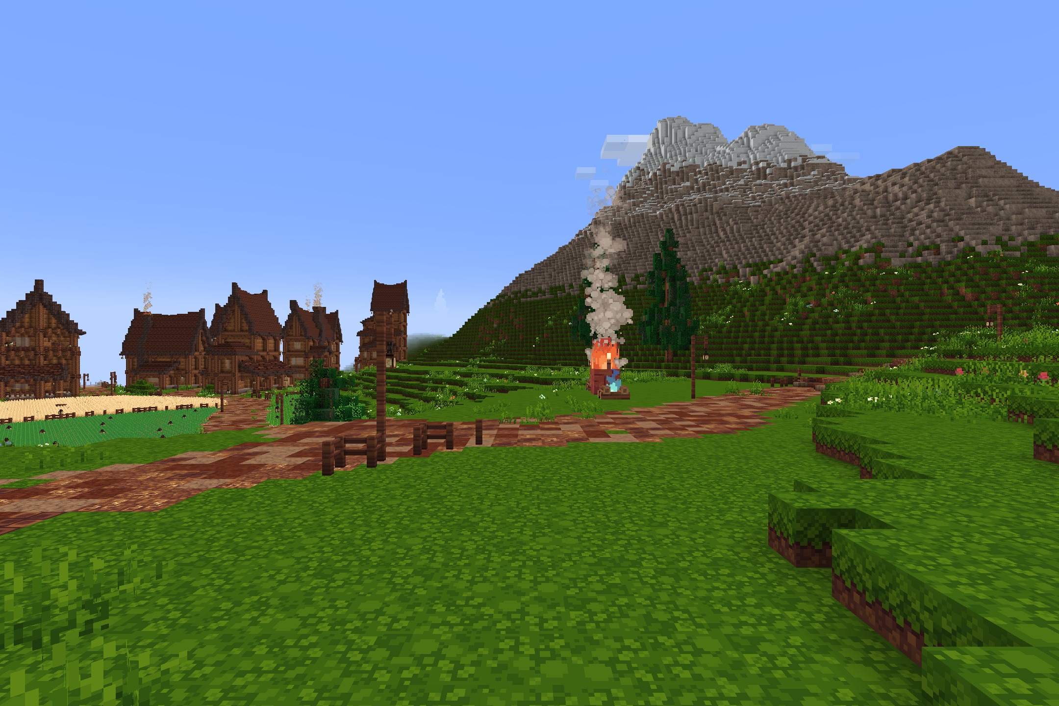 Quadral Pack Resource Pack Screenshot 2 A peaceful village with wooden buildings and a massive mountain in the distance