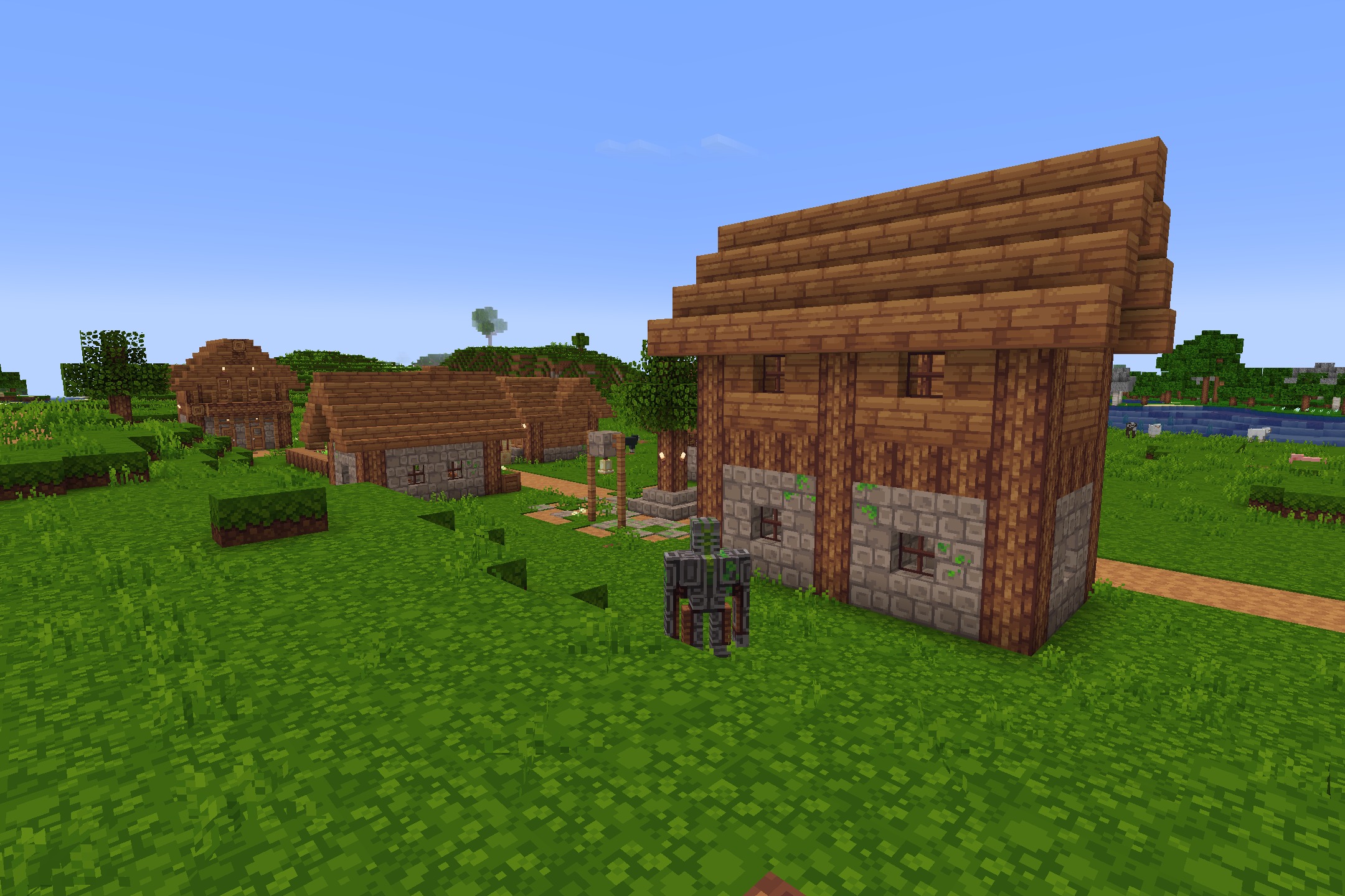 Quadral Pack Resource Pack Screenshot 3 Clean wooden houses and stone buildings stand in a bright green grassy field