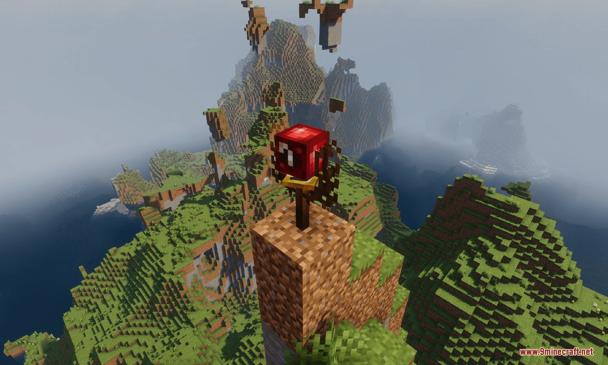A red utility block sits on a dirt pillar overlooking a scenic landscape