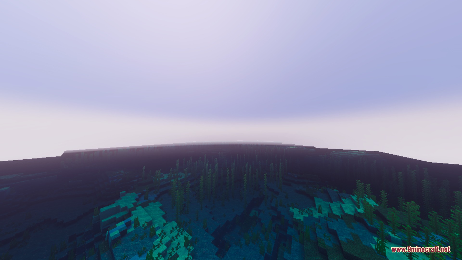 A wide view of a misty Minecraft ocean with kelp underwater