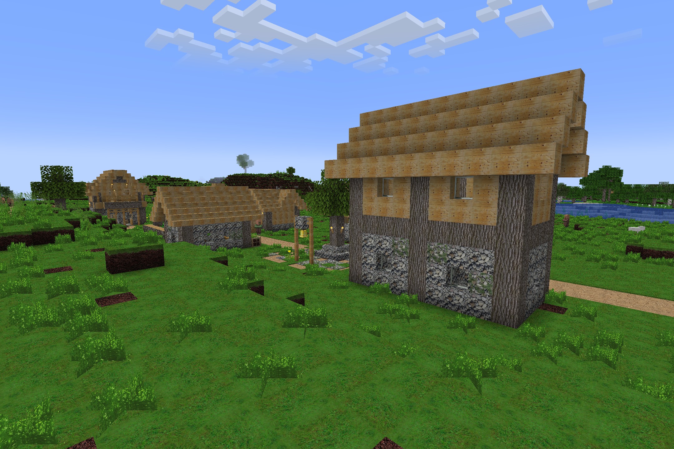 Realism Upscaled Resource Pack Screenshot 3 Village houses showcasing realistic wood and stone textures from the upscaled resource pack