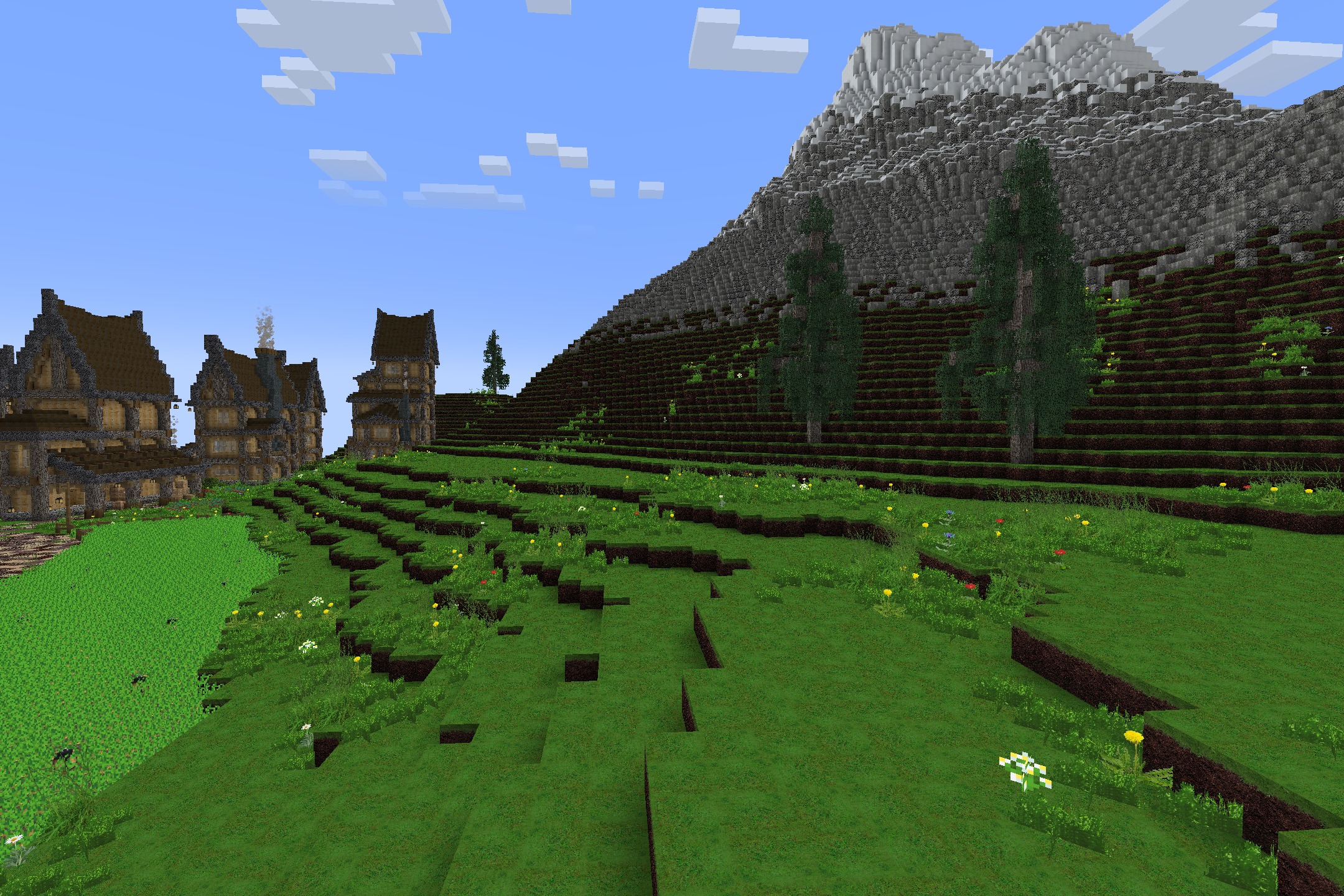 Realism Upscaled Resource Pack Screenshot 4 Lush green hills with realistic grass textures leading to a massive stone mountain