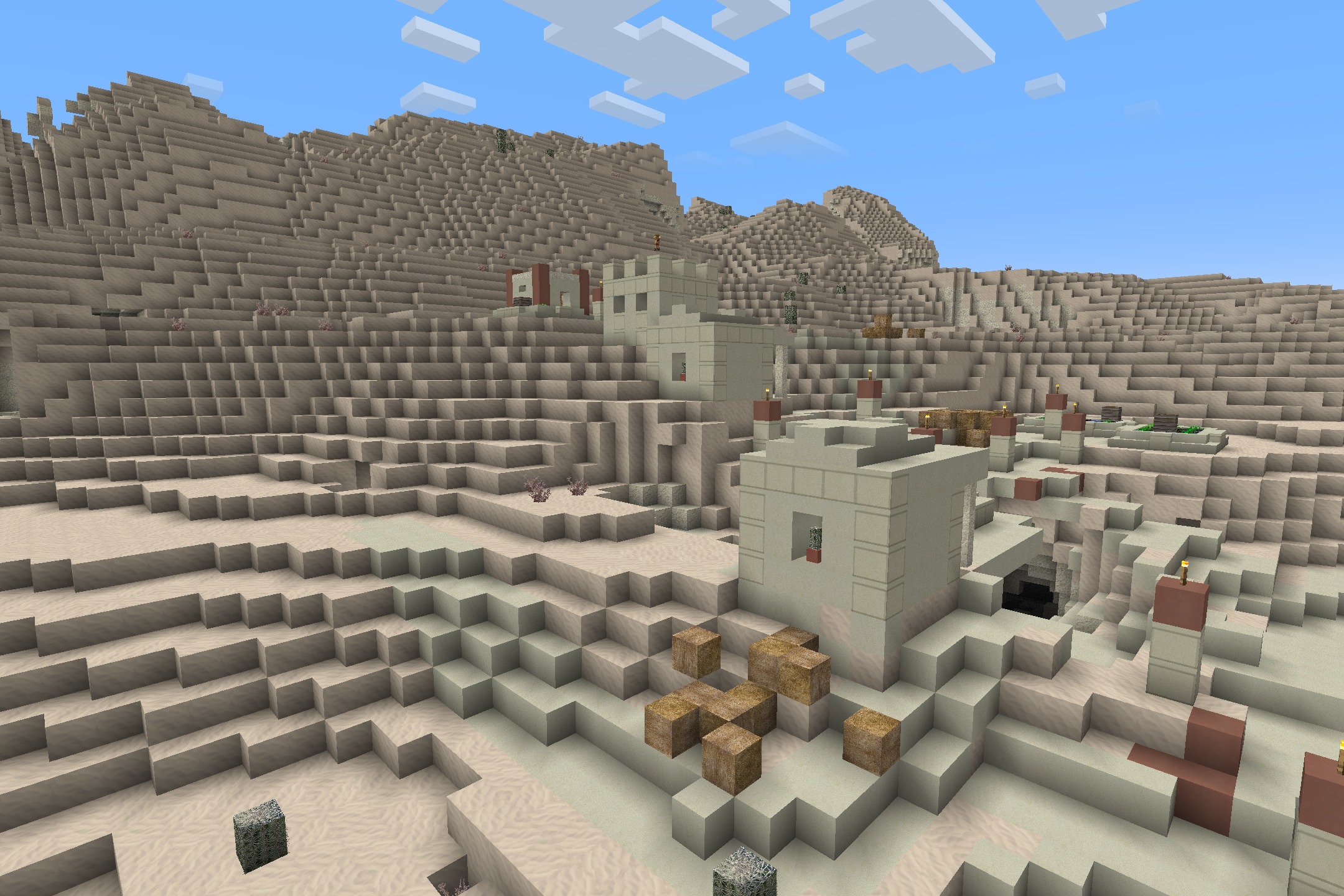 Realism Upscaled Resource Pack Screenshot 5 Realistic desert village with detailed sandstone buildings on a steep sandy hill