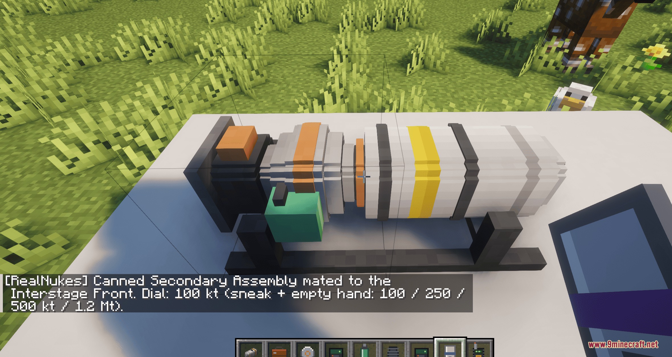 Assembling a nuclear bomb piece by piece on a specialized mounting bracket