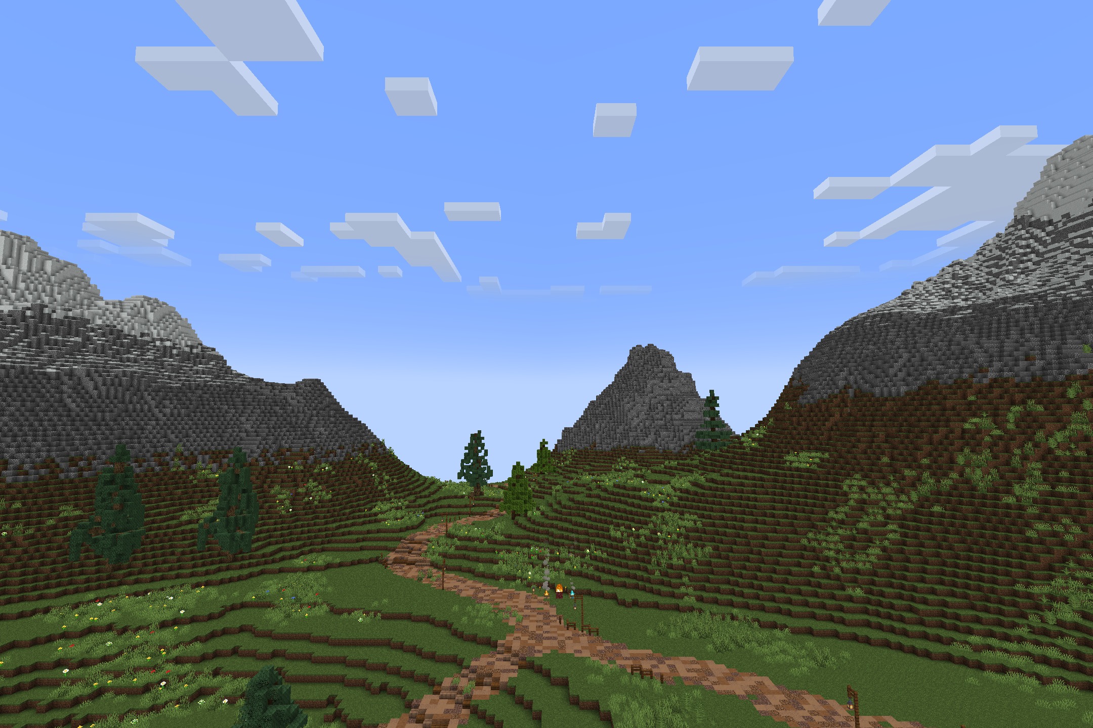 Realtastic X512 PBR POM Resource Pack Screenshot 10 A winding dirt path leads through a valley of detailed green hills and mountains