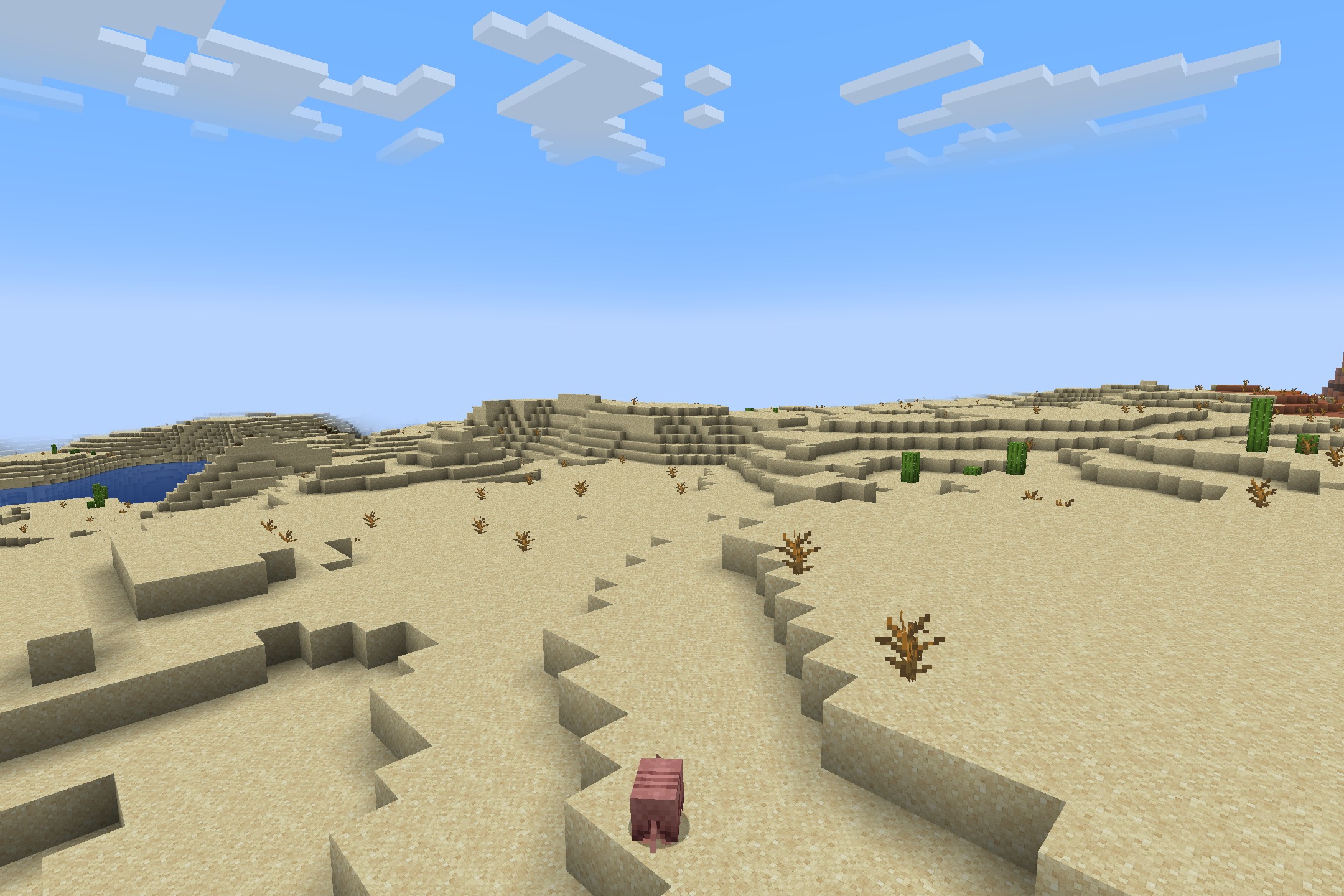 Realtastic X512 PBR POM Resource Pack Screenshot 9 A pig wanders across a desert biome featuring high resolution sand and bushes