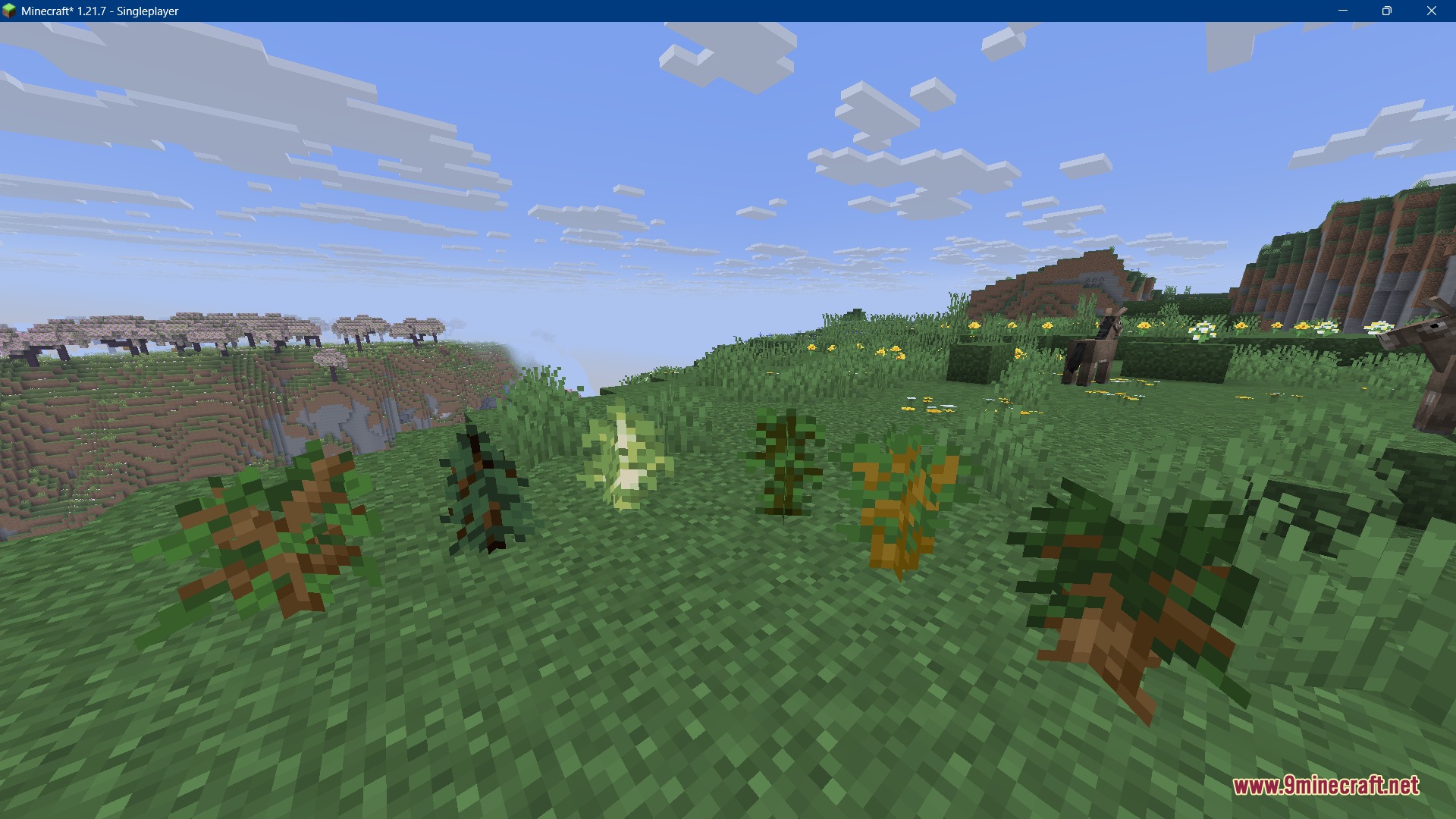 Recolored Plants Resource Pack Screenshot 3 A row of different saplings showing biome matching colors on a grassy field