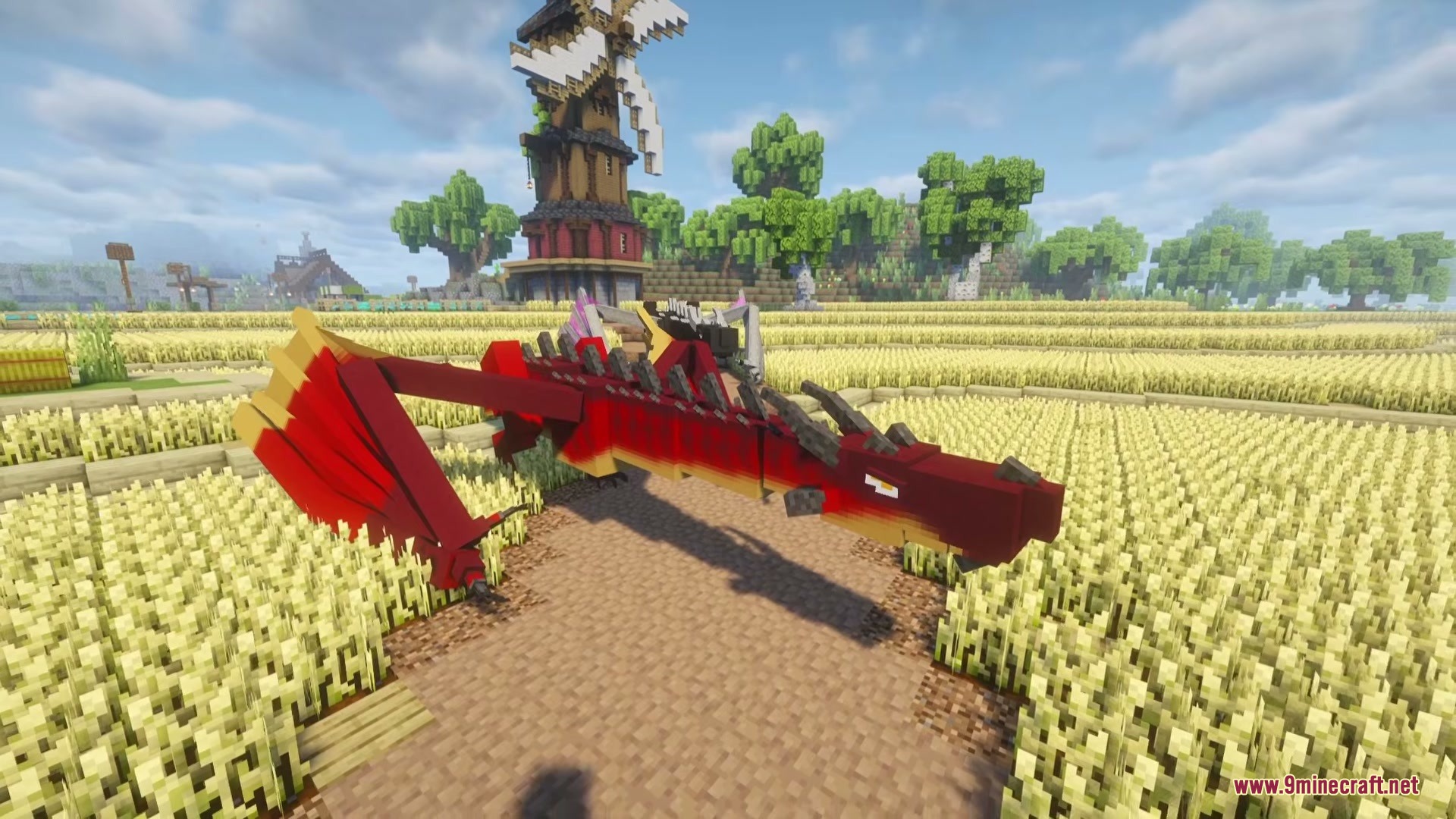 Riders of Dragons Mod Screenshot 6 A red and yellow dragon standing in a wheat field near a windmill