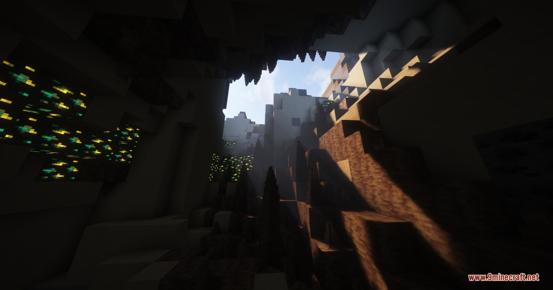 Rocks Done Right Mod Screenshot 1 Sunlight shines into a dark cave with detailed rock formations and glowing ores