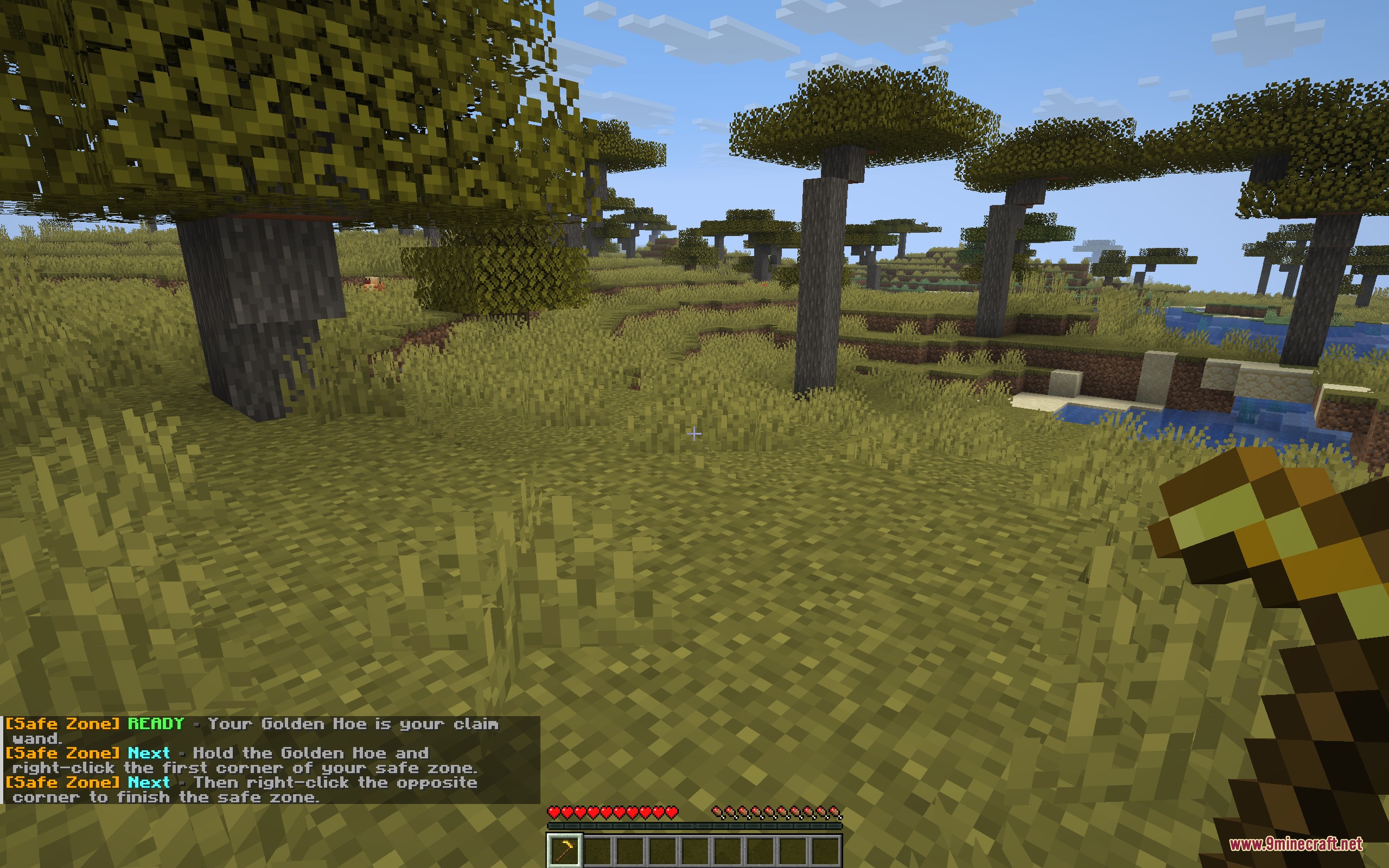 Safe Zone Claims Mod Screenshot 2 A player holds a golden hoe while reading land claiming instructions in chat