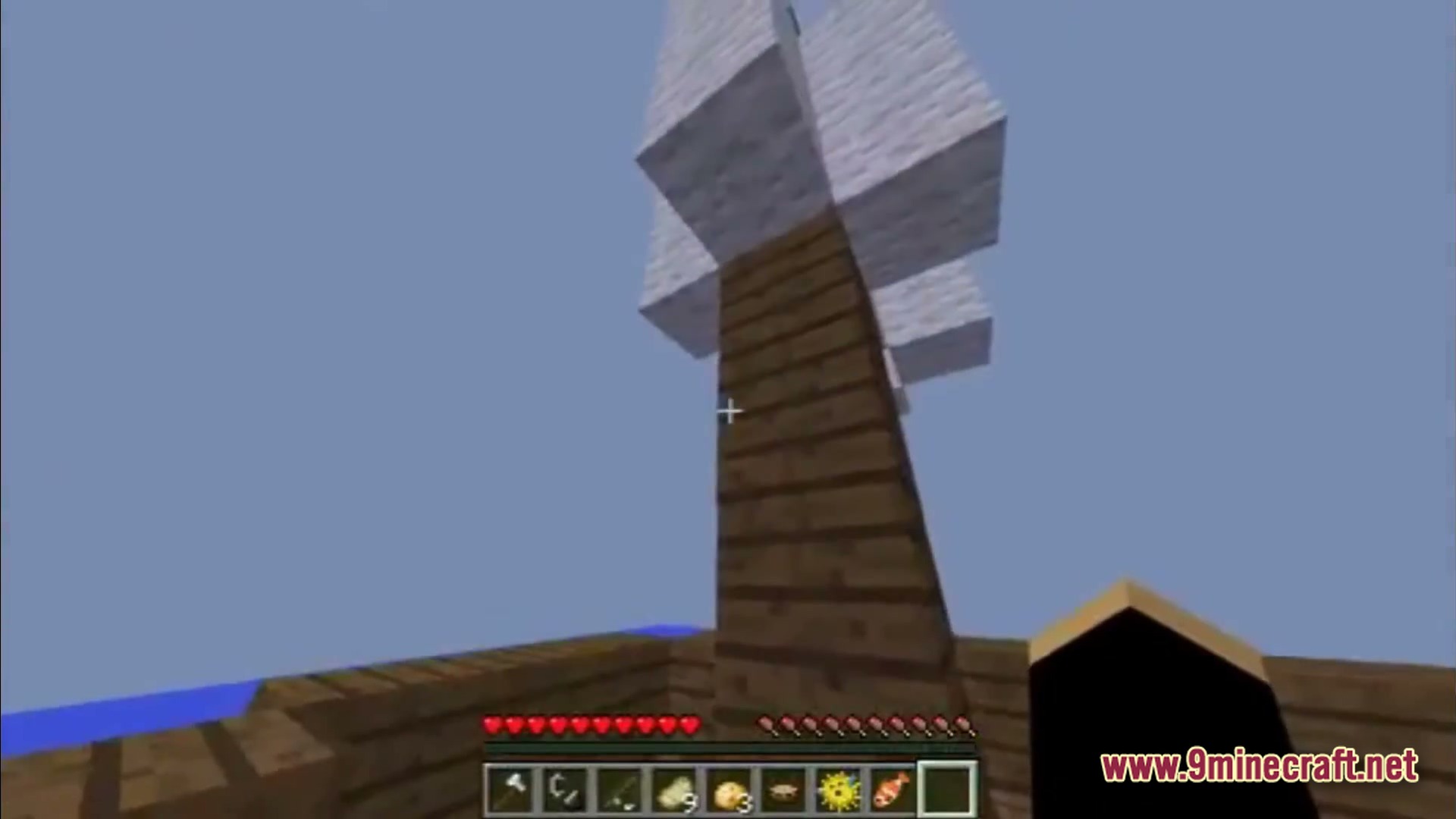 Saltwater Chronicles Modpack Screenshot 1 A first-person view of a wooden ship mast with white wool sails on the open ocean