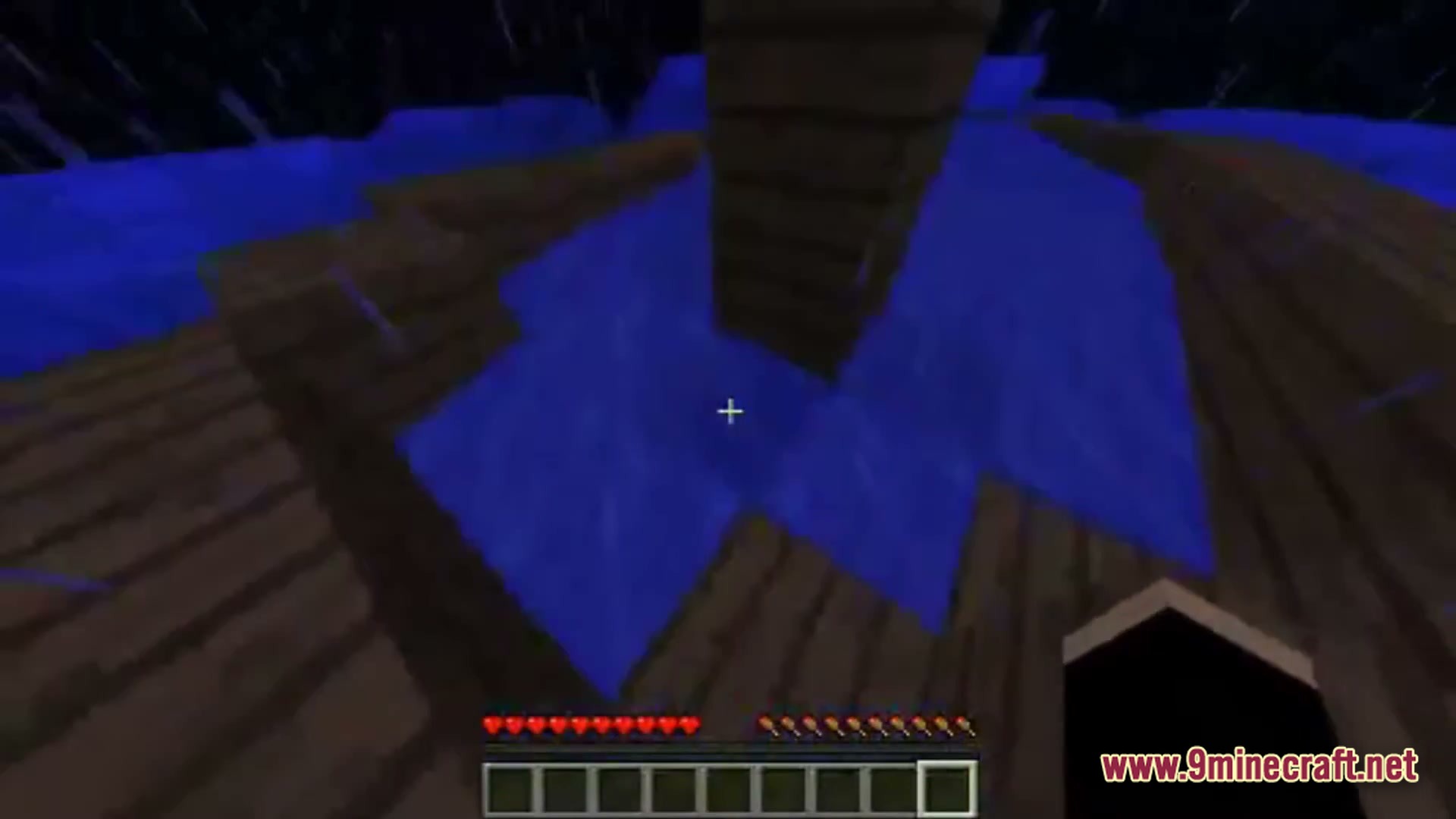 Saltwater Chronicles Modpack Screenshot 6 A first-person view of a wooden boat structure floating on water during a rainstorm at night