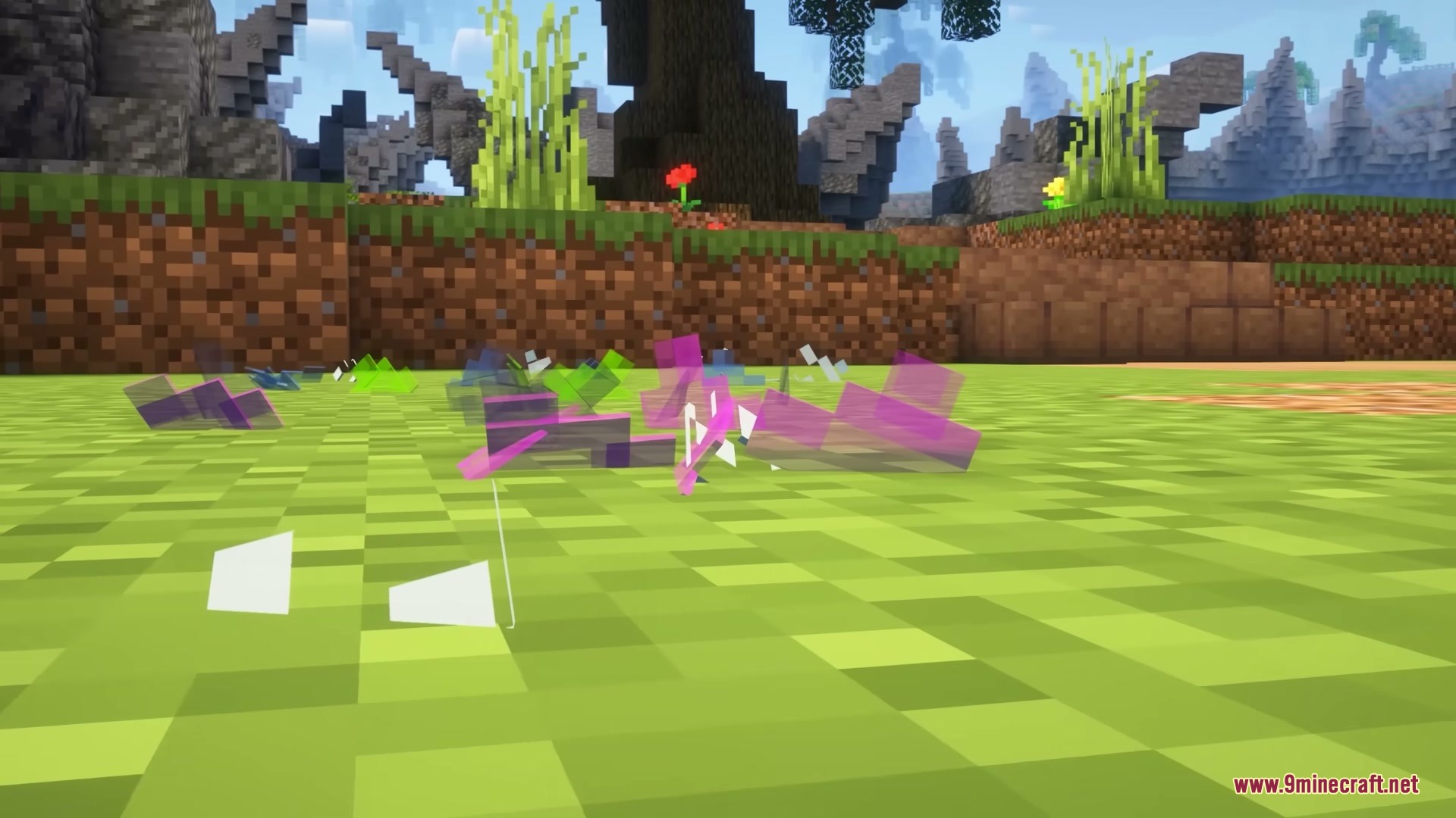 Colorful glass shards scatter across the grass after a block breaks