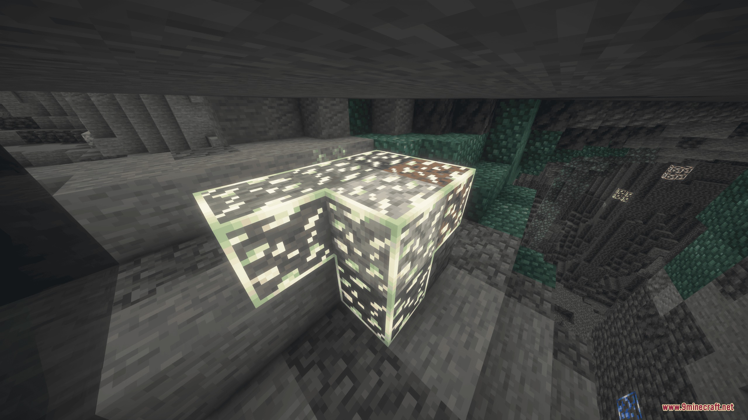 Connected glowing ore blocks lighting up the interior of a dark cave