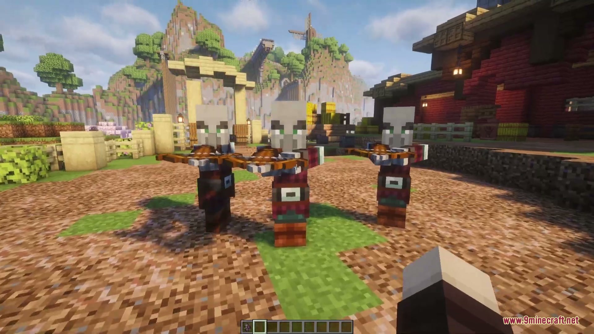 Three Pillagers stand in a row with crossbows in a village setting