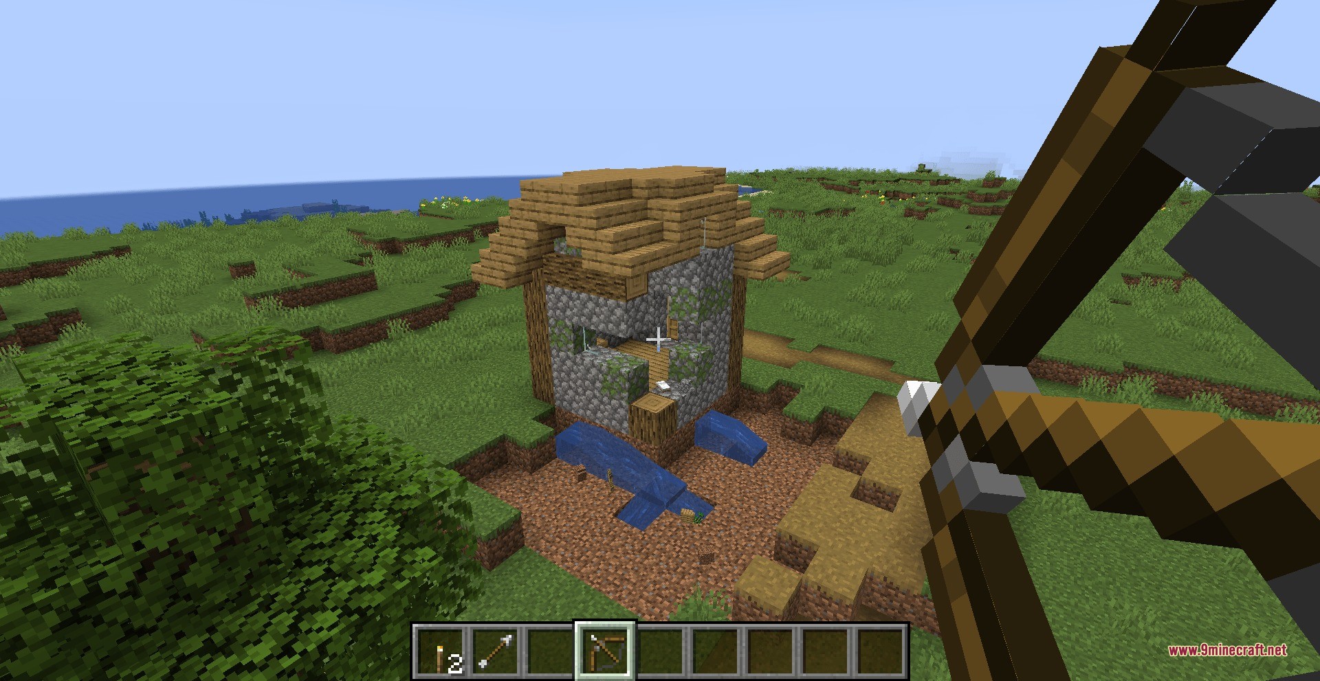 Shatterbolt Artillery Data Pack Screenshot 2 Player aiming a bow at a house using Shatterbolt Artillery data pack