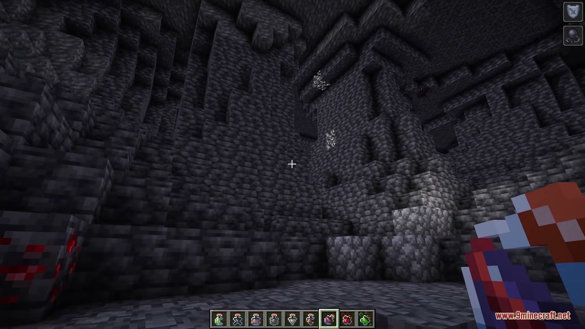 Shureee's Potions Resource Pack Screenshot 4 A player holds a custom shaped potion bottle in a dark cave