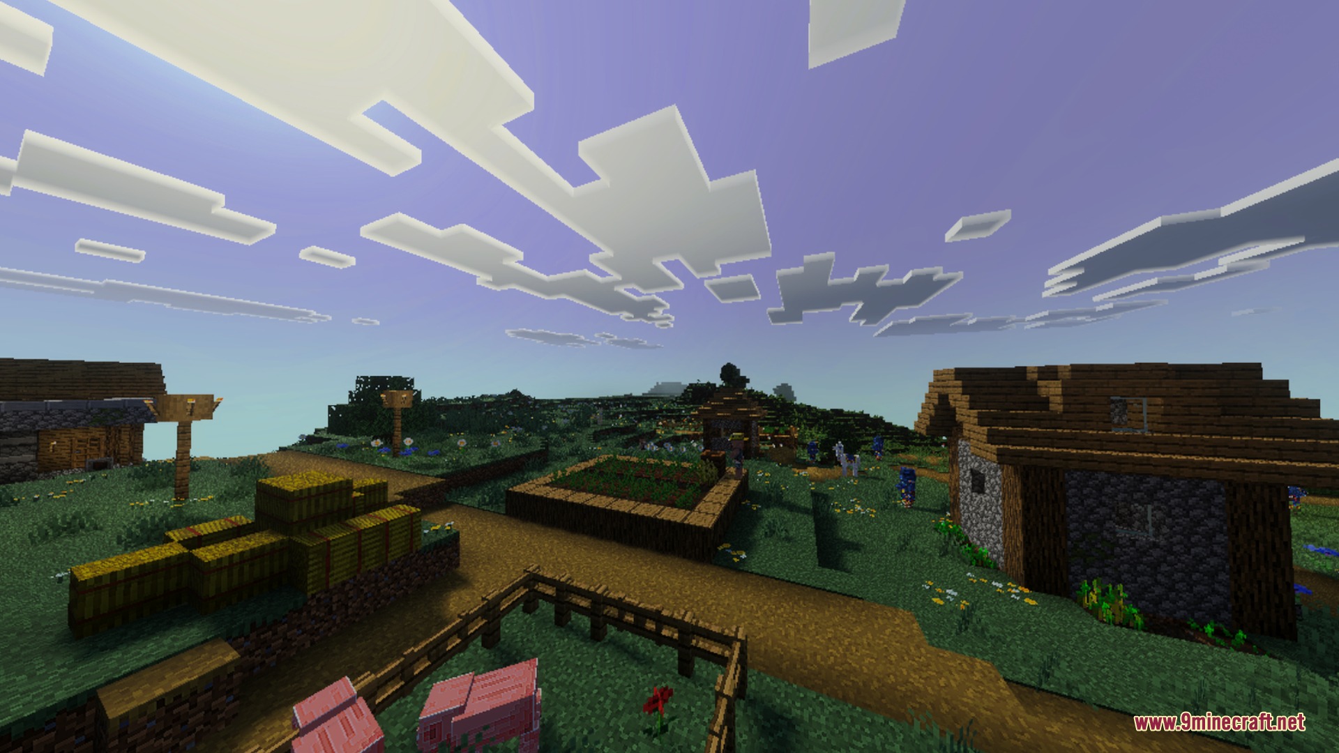 A peaceful village with wooden houses and hay bales under a bright sky