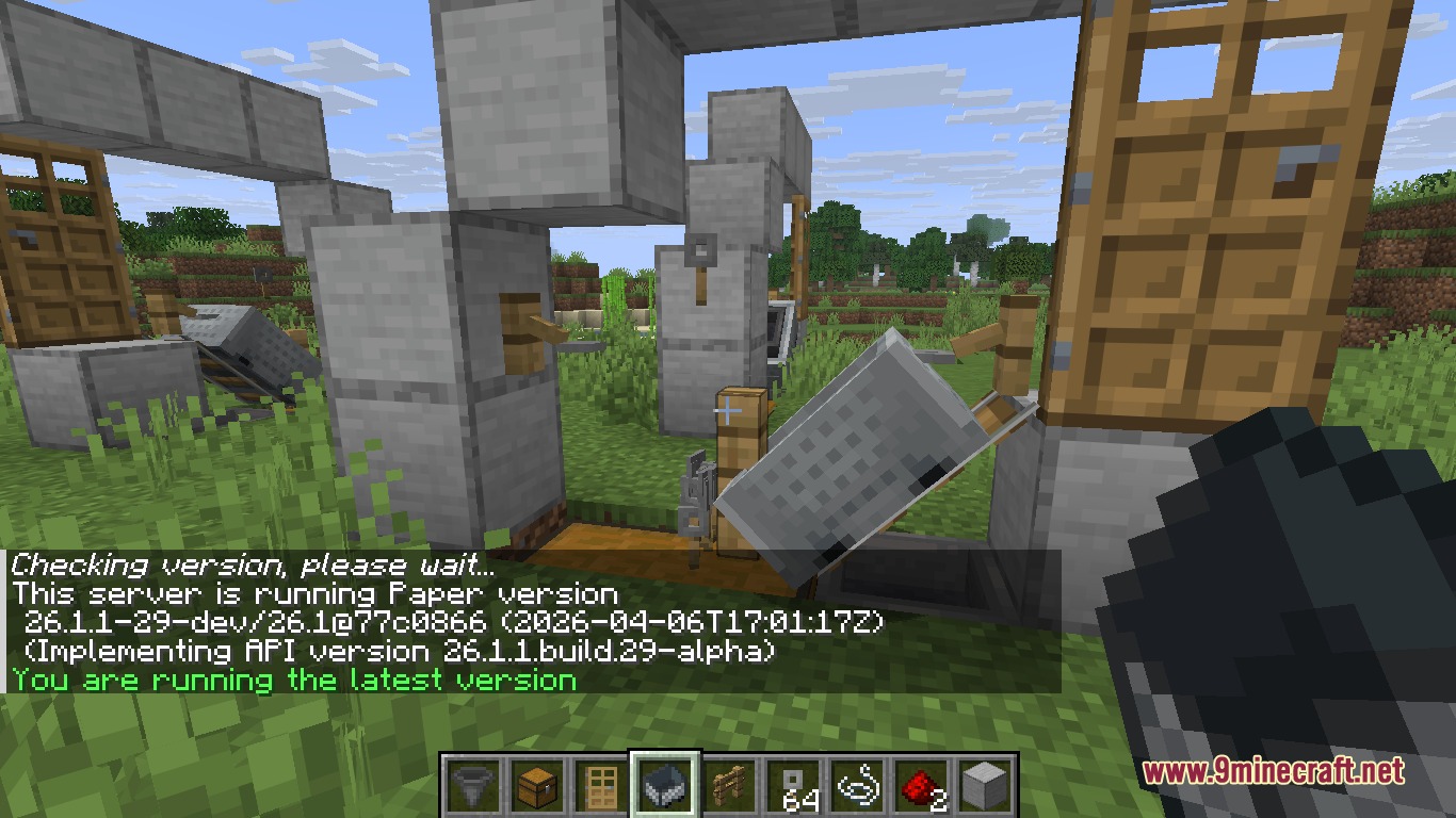 Player holding a minecart while looking at a tripwire hook duplication machine