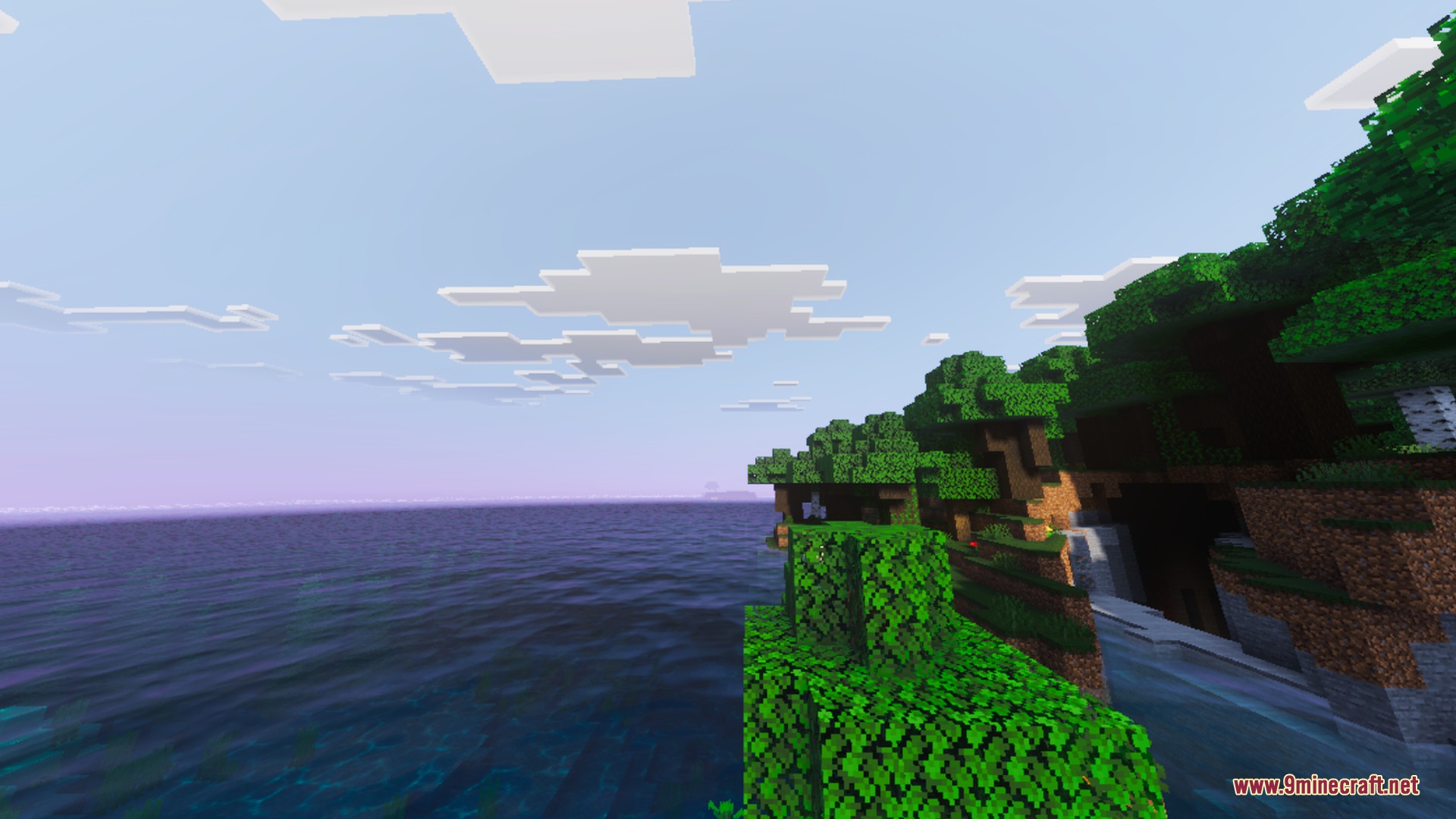 Simplistic Shader Screenshot 2 Scenic coastal view featuring green trees and realistic clouds with warm sunlight