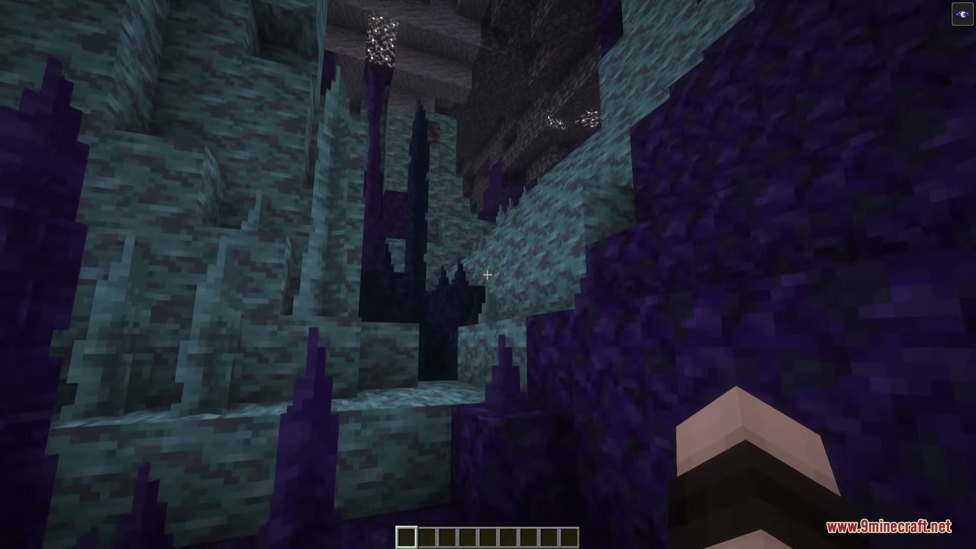 Simply Cave Biomes Mod Screenshot 1 Player explores a cave with purple Heterosite stalagmites and teal stone walls