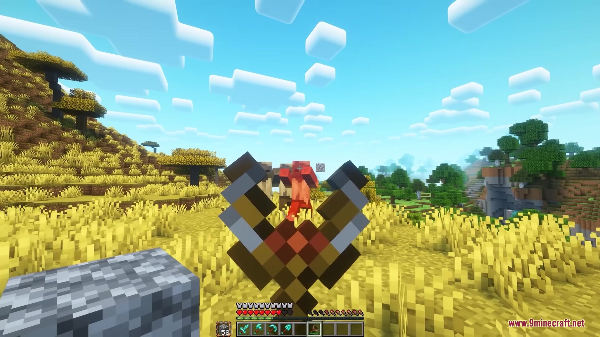 Simply Slingshot Mod Screenshot 4 A player targets a red mob with a slingshot in the savanna