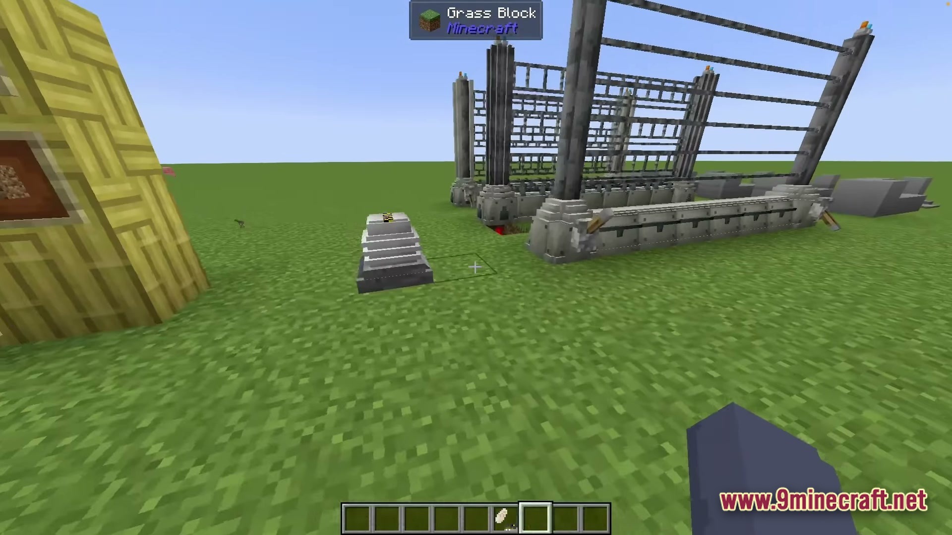 Sinothe Dino's Dinosaurs Modpack Screenshot 4 A large industrial metal fence structure and control terminal stand on a flat grass plain