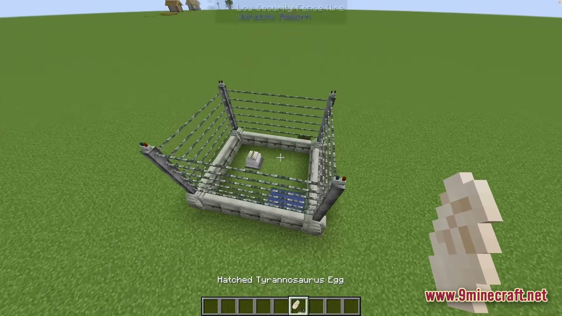 Sinothe Dino's Dinosaurs Modpack Screenshot 5 A small fenced enclosure containing a feeder and water source on a flat grass plain