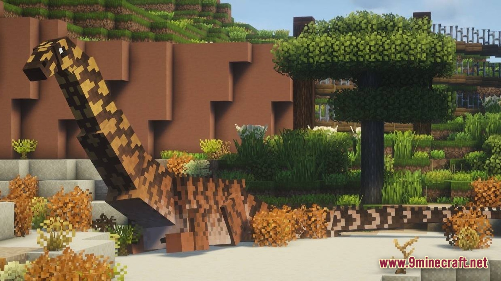 Sinothe Dino's Dinosaurs Modpack Screenshot 9 A long-necked dinosaur stands in a custom-built enclosure featuring diverse vegetation and stone walls