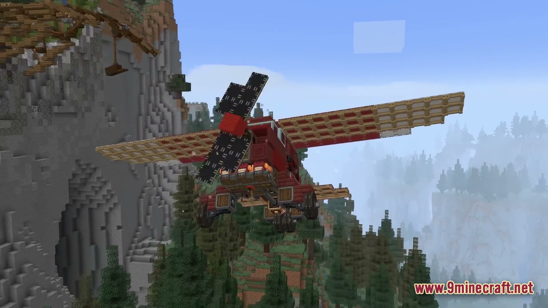 Skybound Engineering Alpha Modpack Screenshot 1 A red propeller airplane flies over a dense evergreen forest near a steep mountain cliff