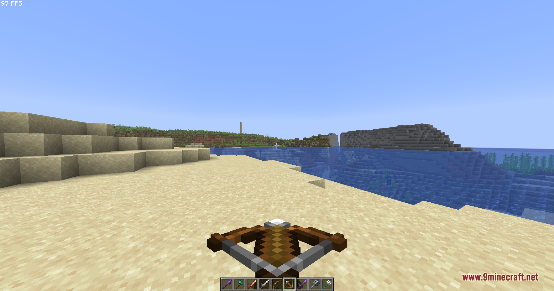 Small Hand Tools Resource Pack Screenshot 1 A player holds a smaller crossbow while standing on a sandy beach