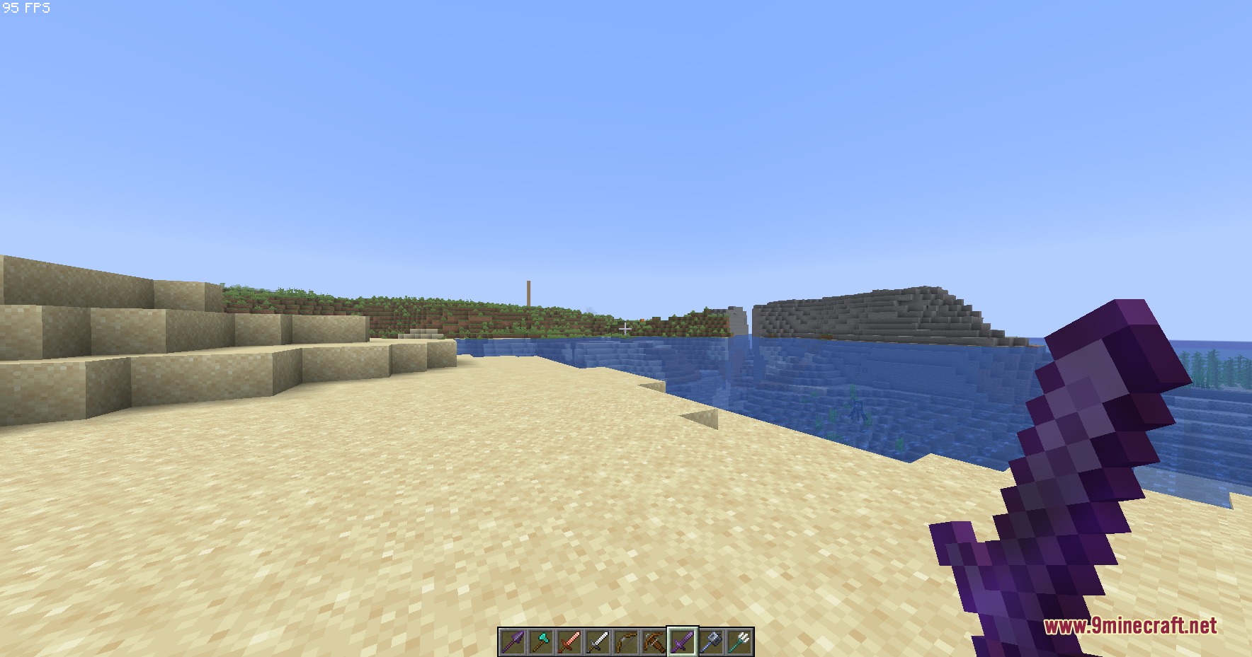 Small Hand Tools Resource Pack Screenshot 3 Player holding a small netherite sword while standing on a sandy beach