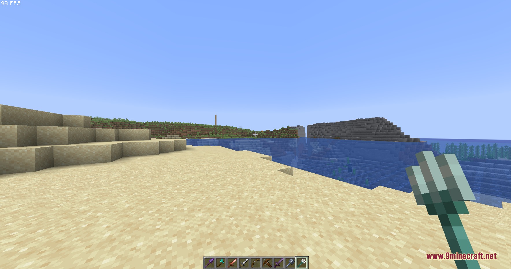 Small Hand Tools Resource Pack Screenshot 5 A player holds a small trident while standing on a sandy beach