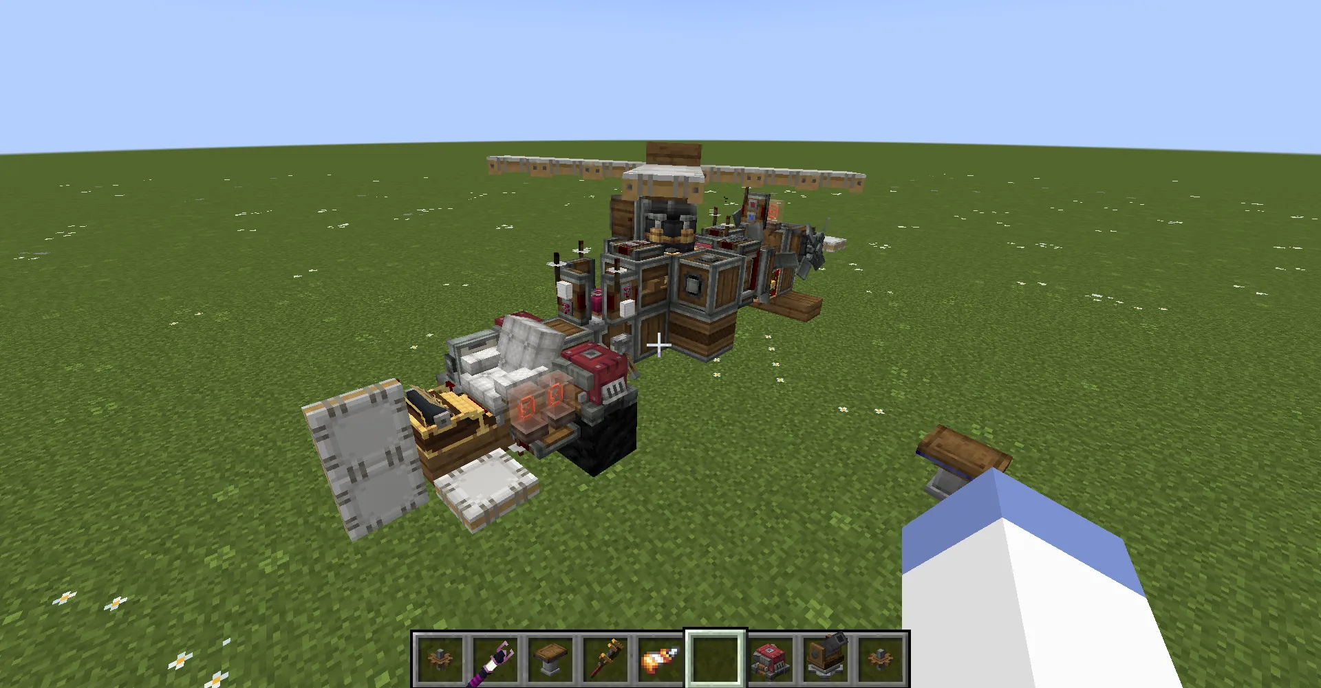 A small helicopter schematic built with various blocks on a grass field