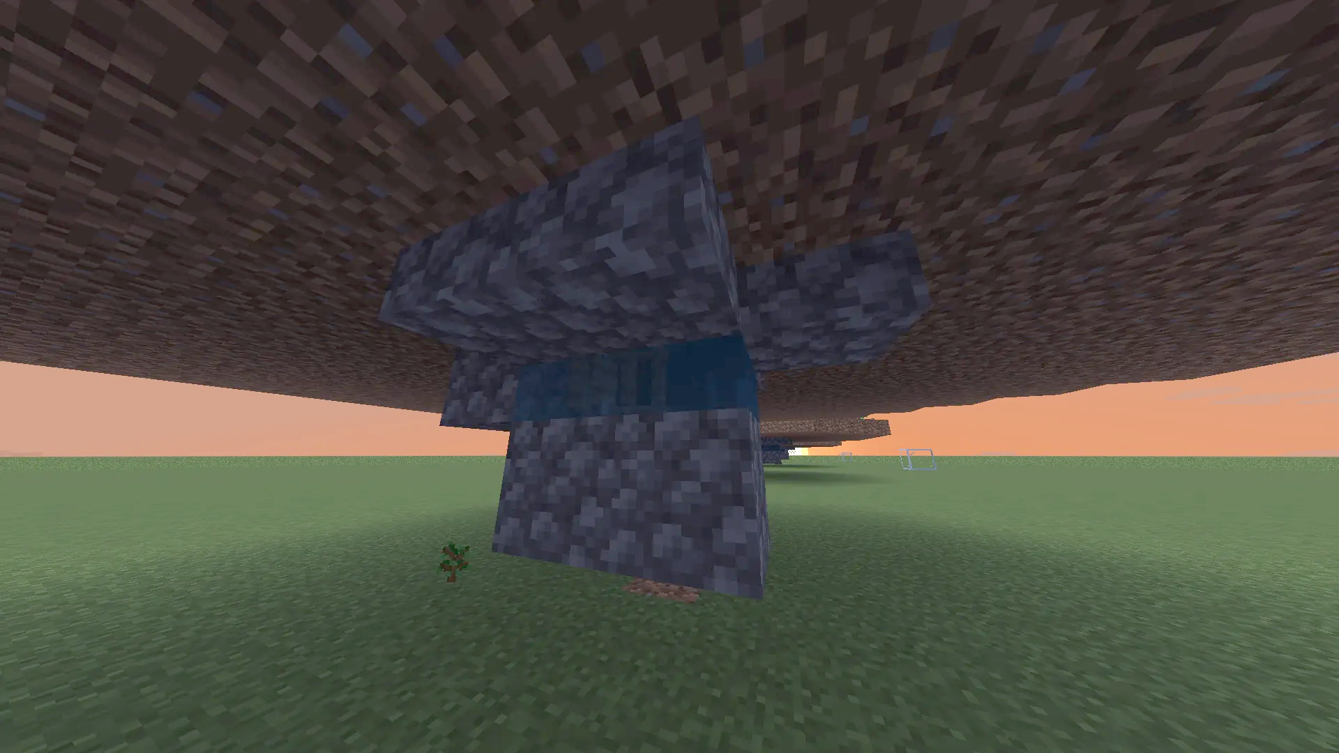 Cobblestone and water mechanism built under a floating dirt platform in Minecraft