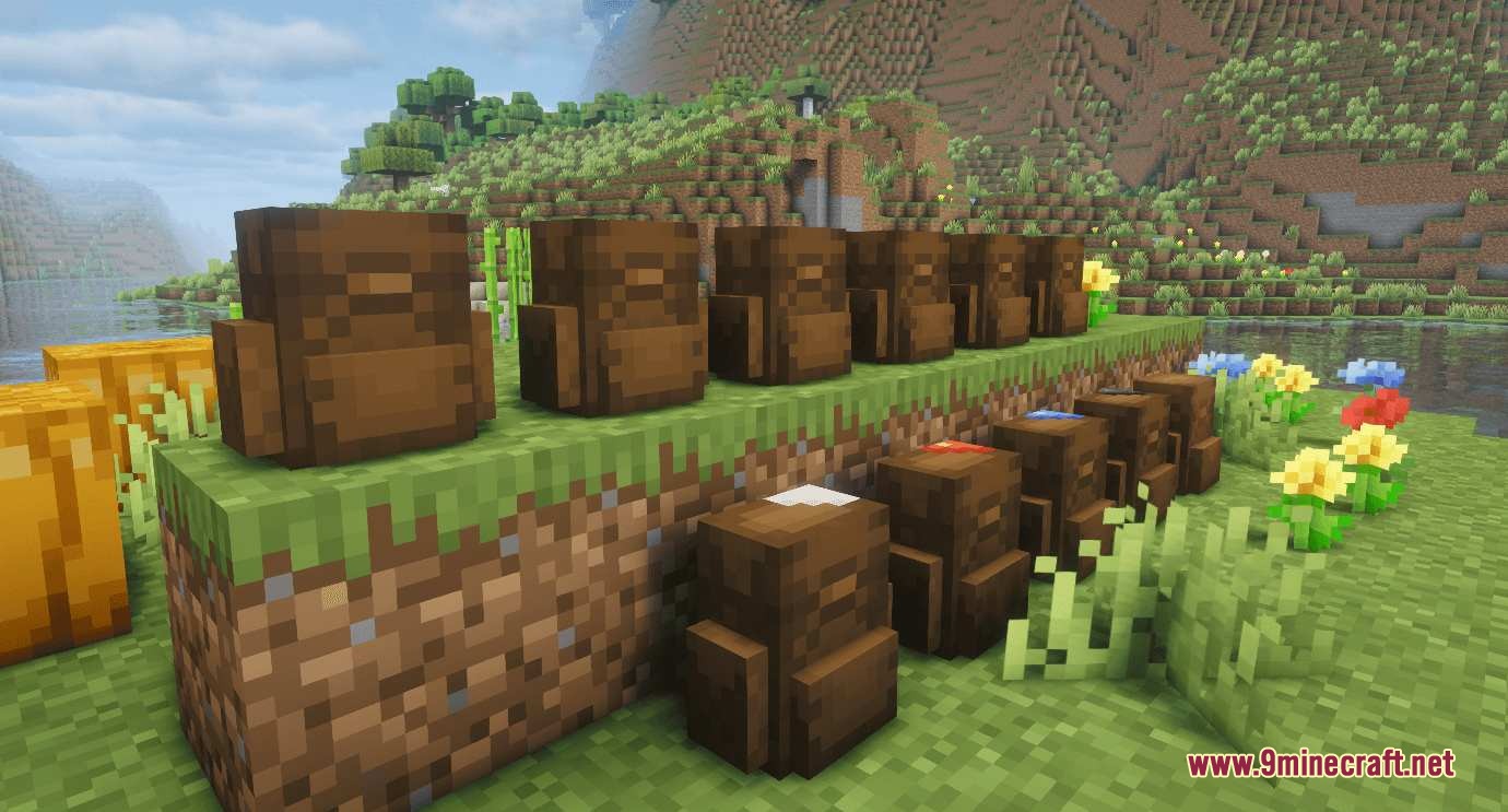 Smart Back Packs Mod Screenshot 8 Various tiers of brown backpacks placed on grass blocks near a river