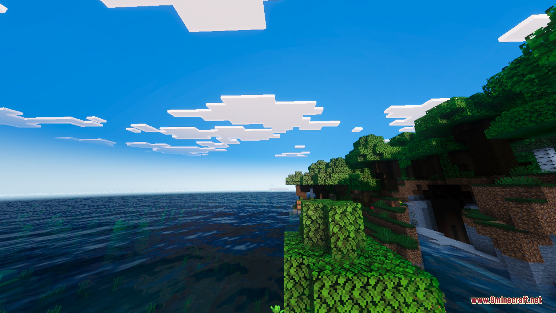 Solumn Visuals Shader Screenshot 2 A scenic coastal landscape with a lush forest overlooking the vast blue ocean