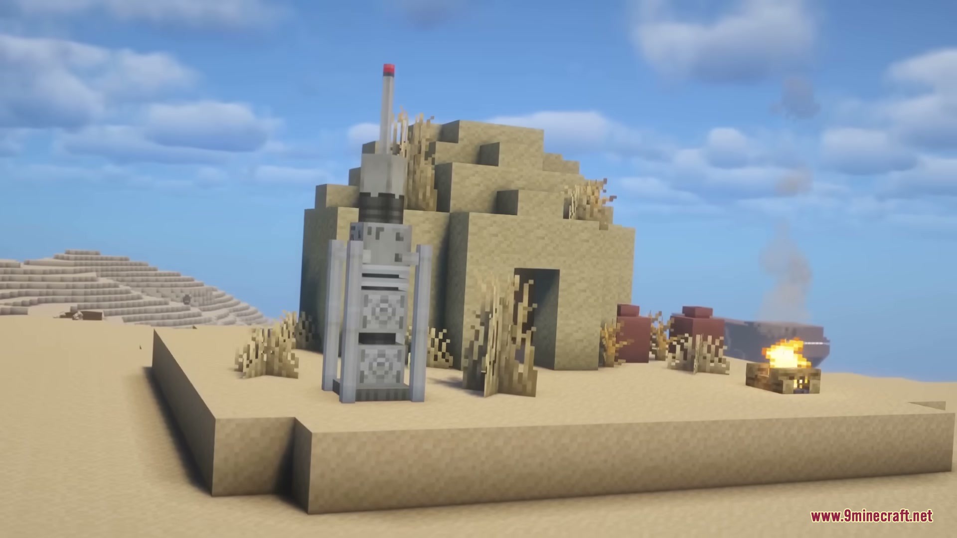 A desert settlement featuring a sandstone hut and a tall moisture vaporator