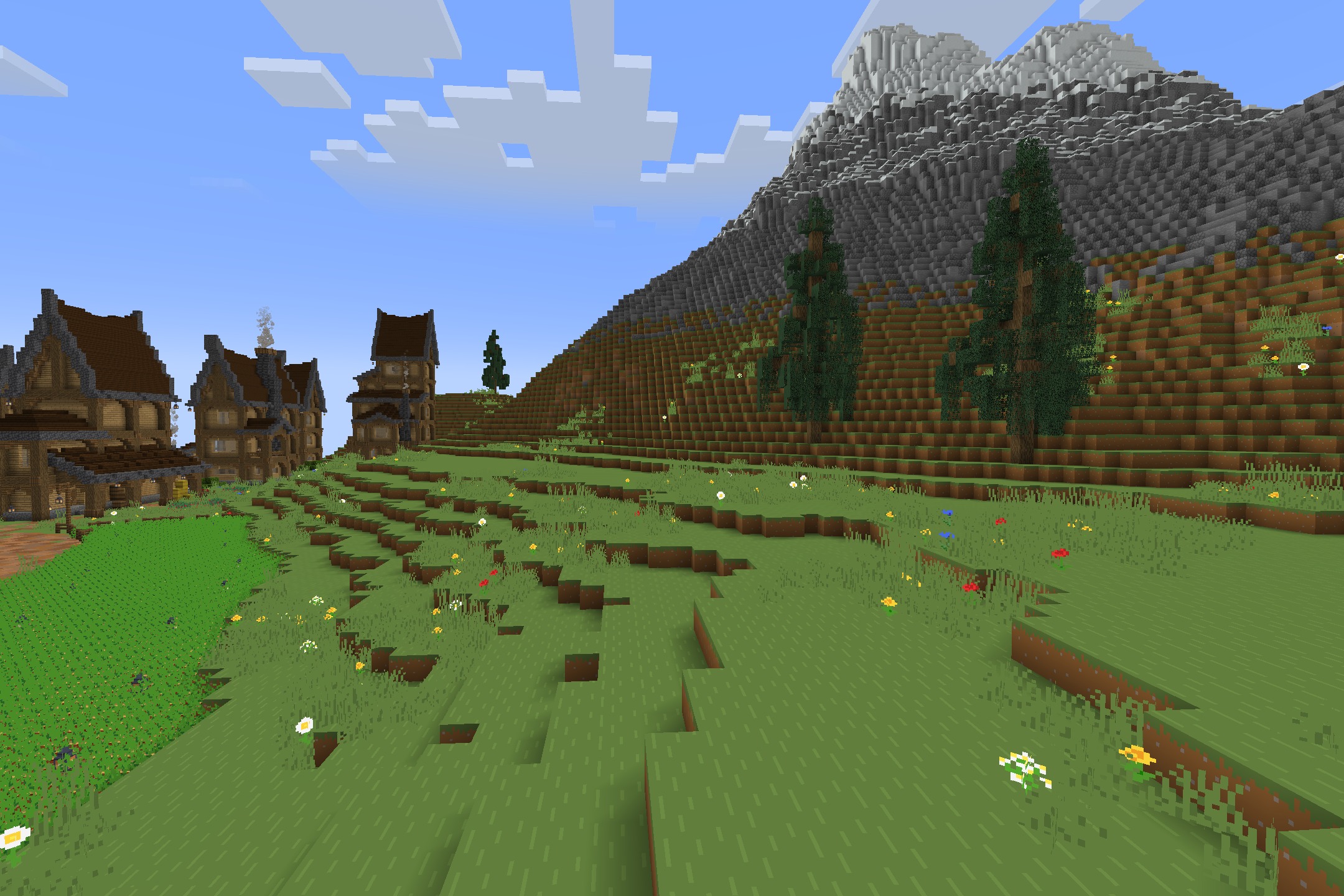 Starboyz2743 PvP Pack Resource Pack Screenshot 4 A massive stone mountain towers over a grassy field filled with flowers