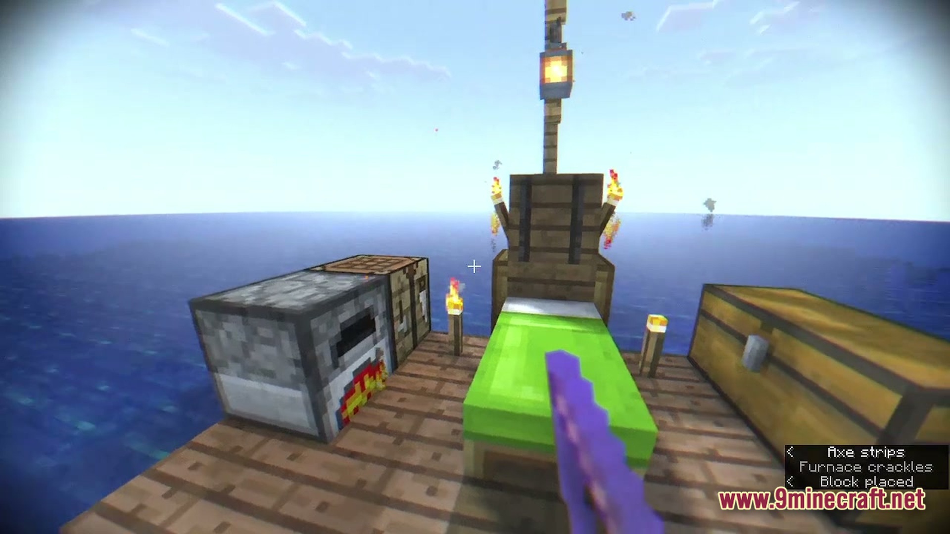 A wooden raft on the ocean featuring a furnace, crafting table, bed, and storage chest