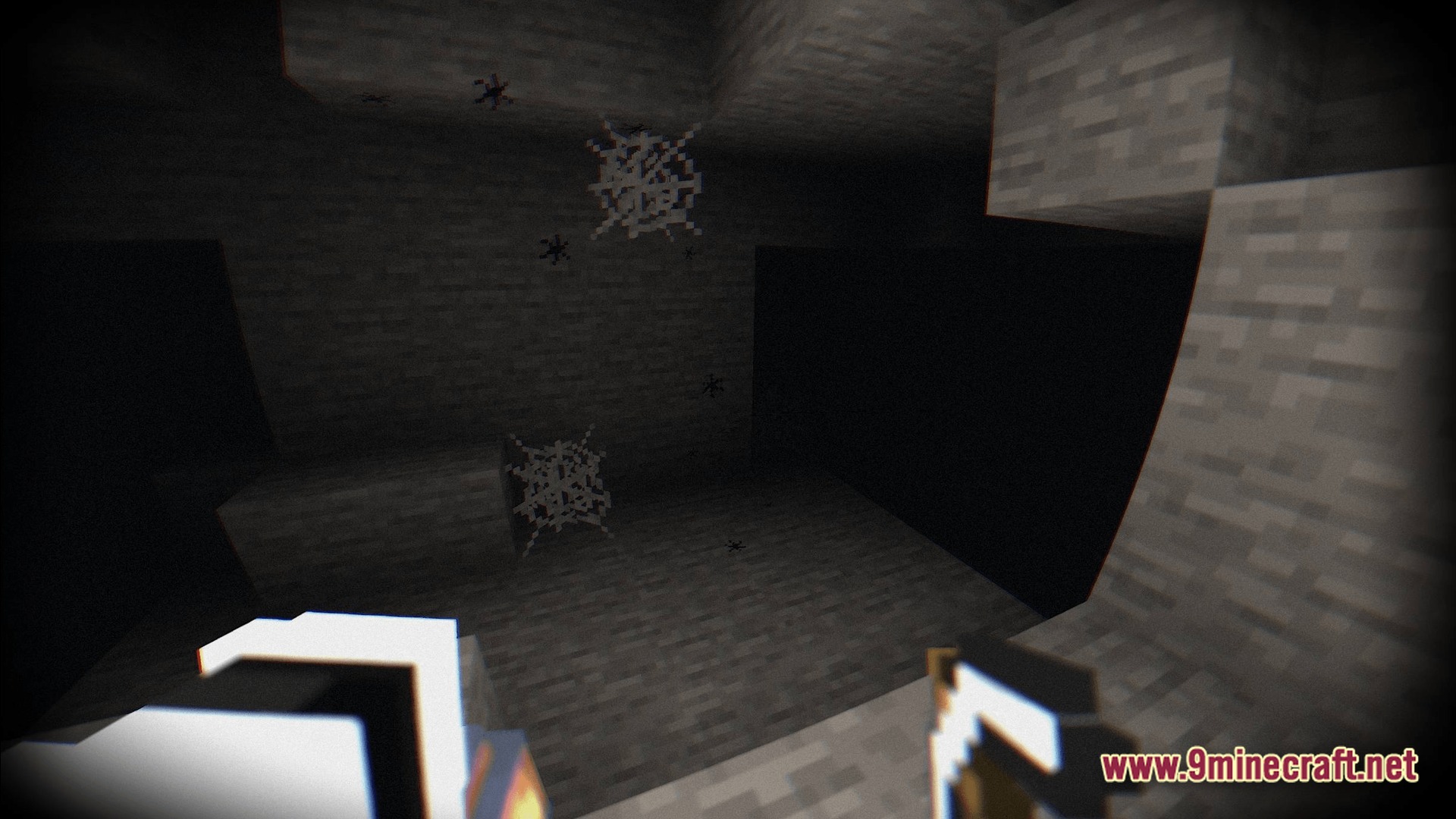 Cobwebs and small spiders inside a dark stone cave with a grainy visual filter applied