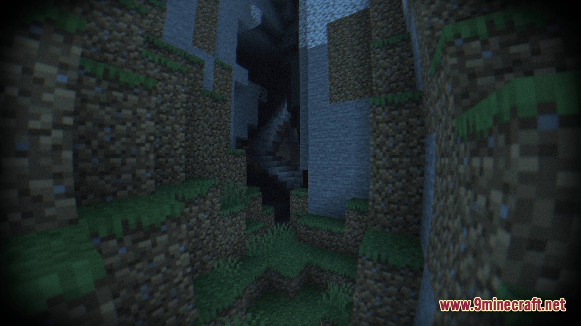 A dark cave entrance nestled between steep dirt and stone cliffs with a grainy visual filter