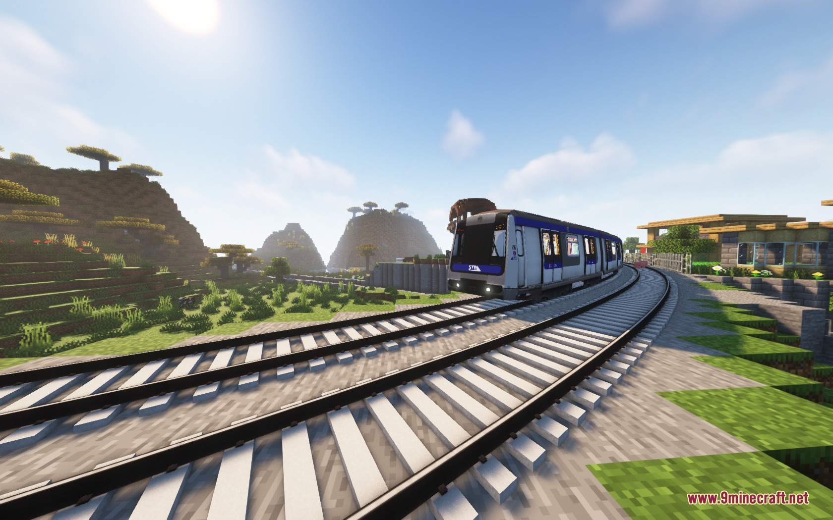 Steel Transit Blueprints Resource Pack Screenshot 5 A blue and white train traveling on curved tracks through a Minecraft savanna