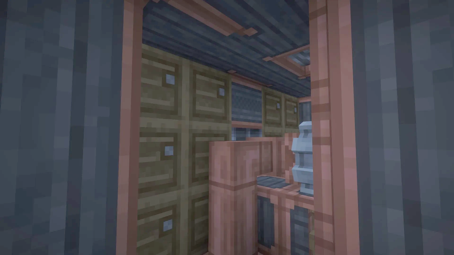 Storage lockers and copper framing within the dark submarine lower deck