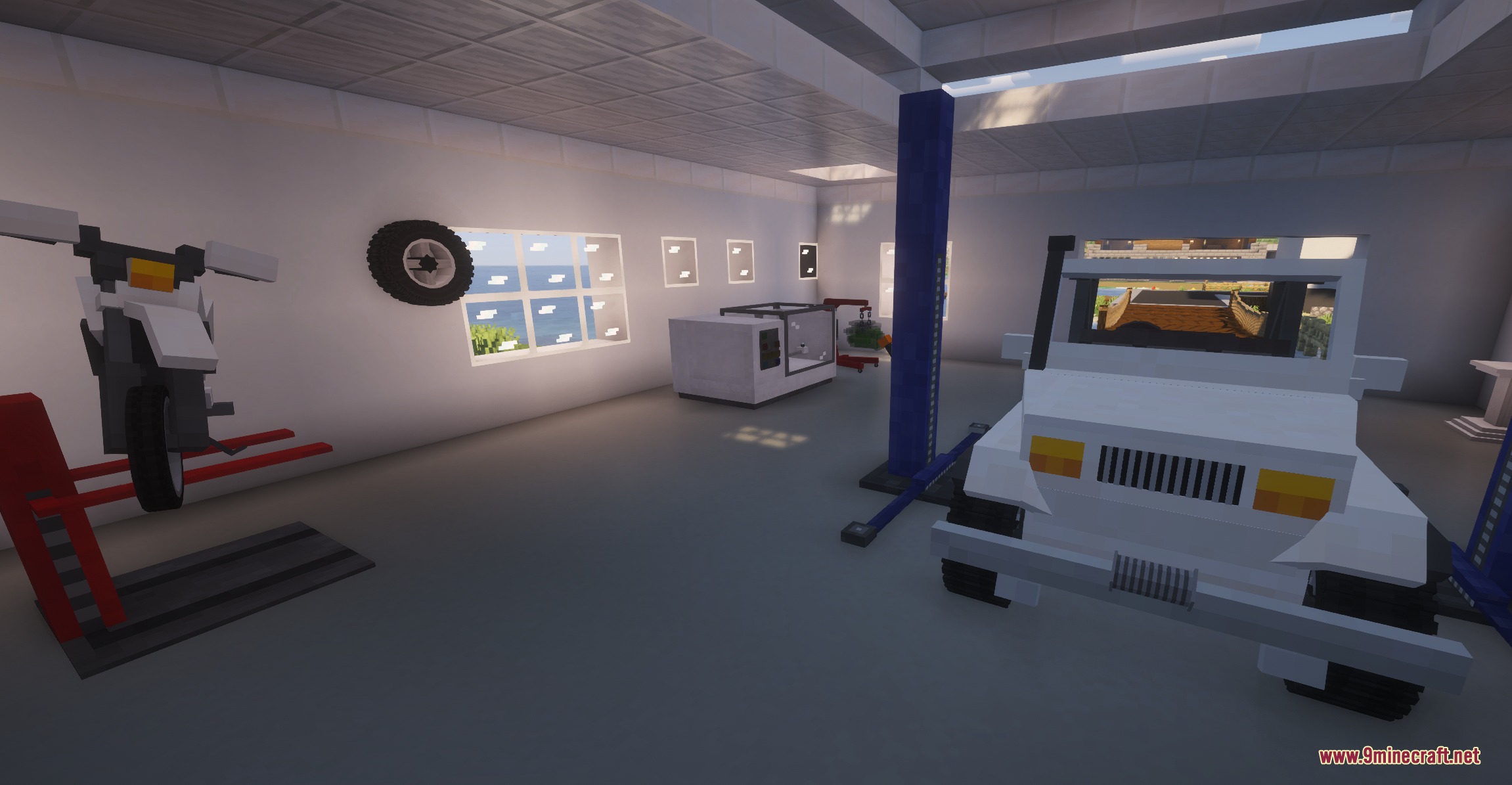 Inside a vehicle workshop with a white car and motorcycle on stands