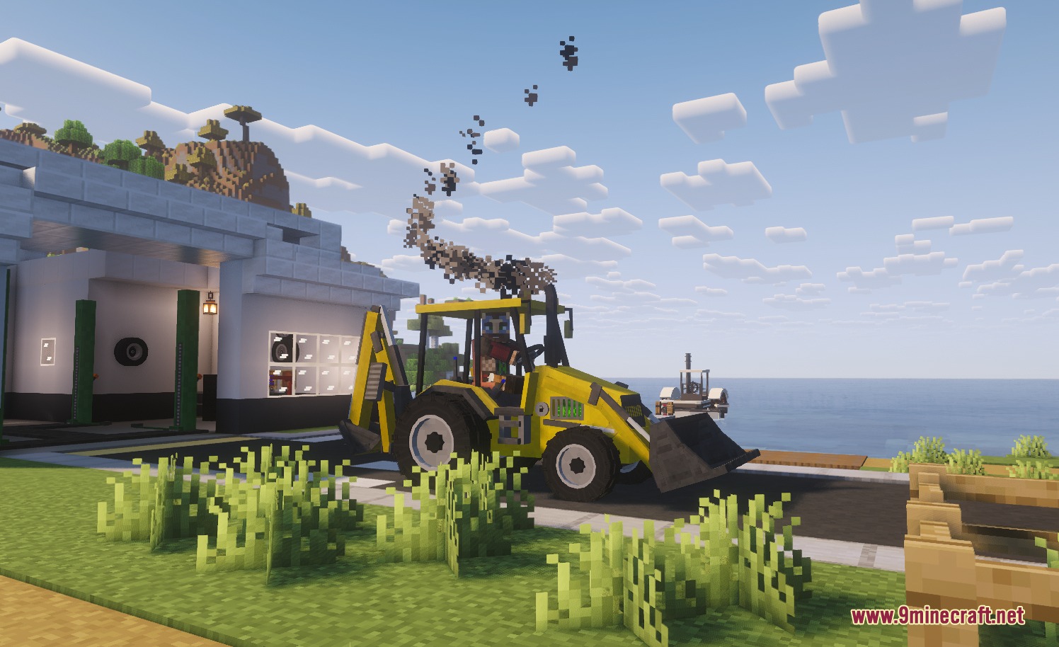 A yellow backhoe loader emitting smoke while parked next to a white building