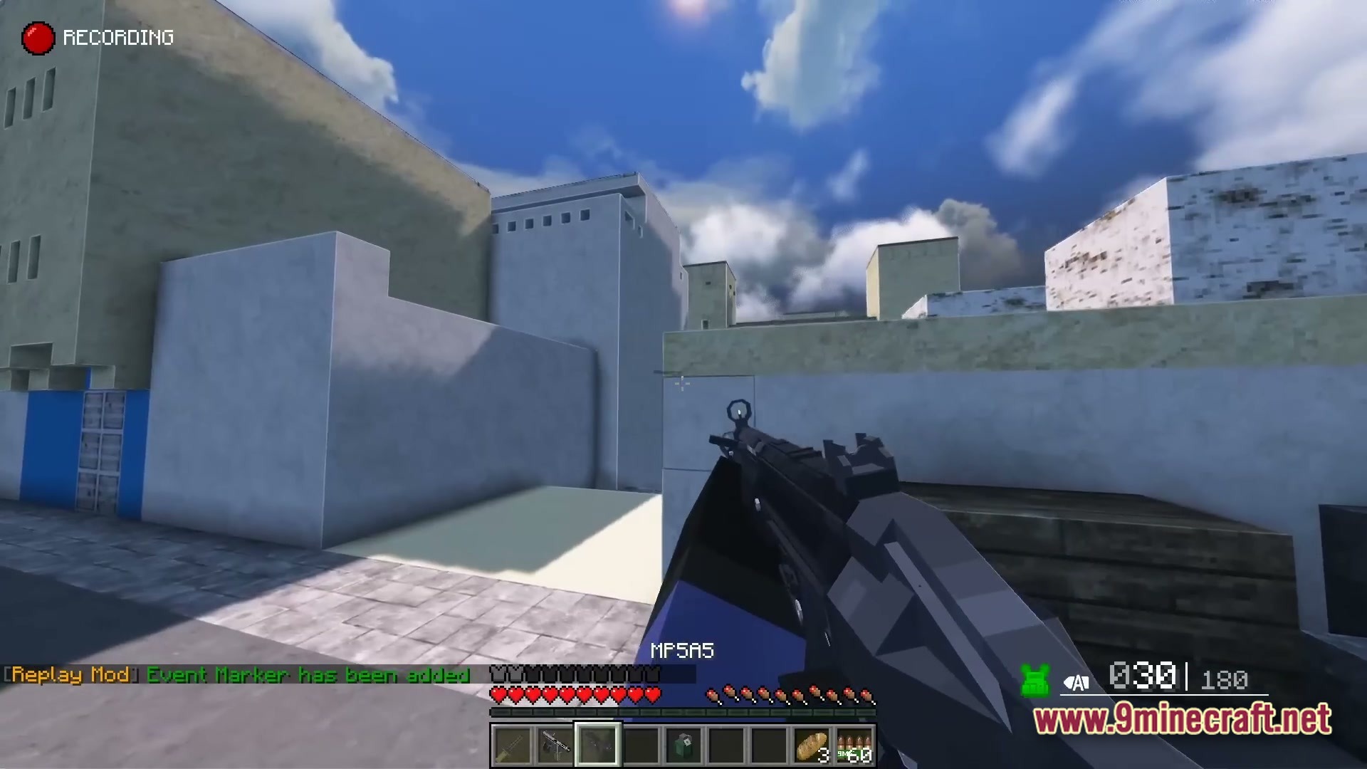 A first-person perspective of a player holding an MP5A5 submachine gun in an urban environment