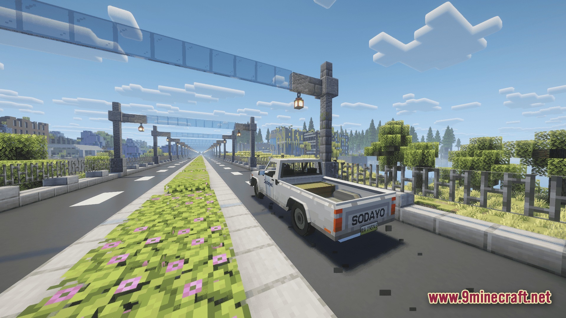 Take A Look GUNS Remasterd Modpack Screenshot 2 A white pickup truck drives along a modern paved road lined with streetlights and flower beds