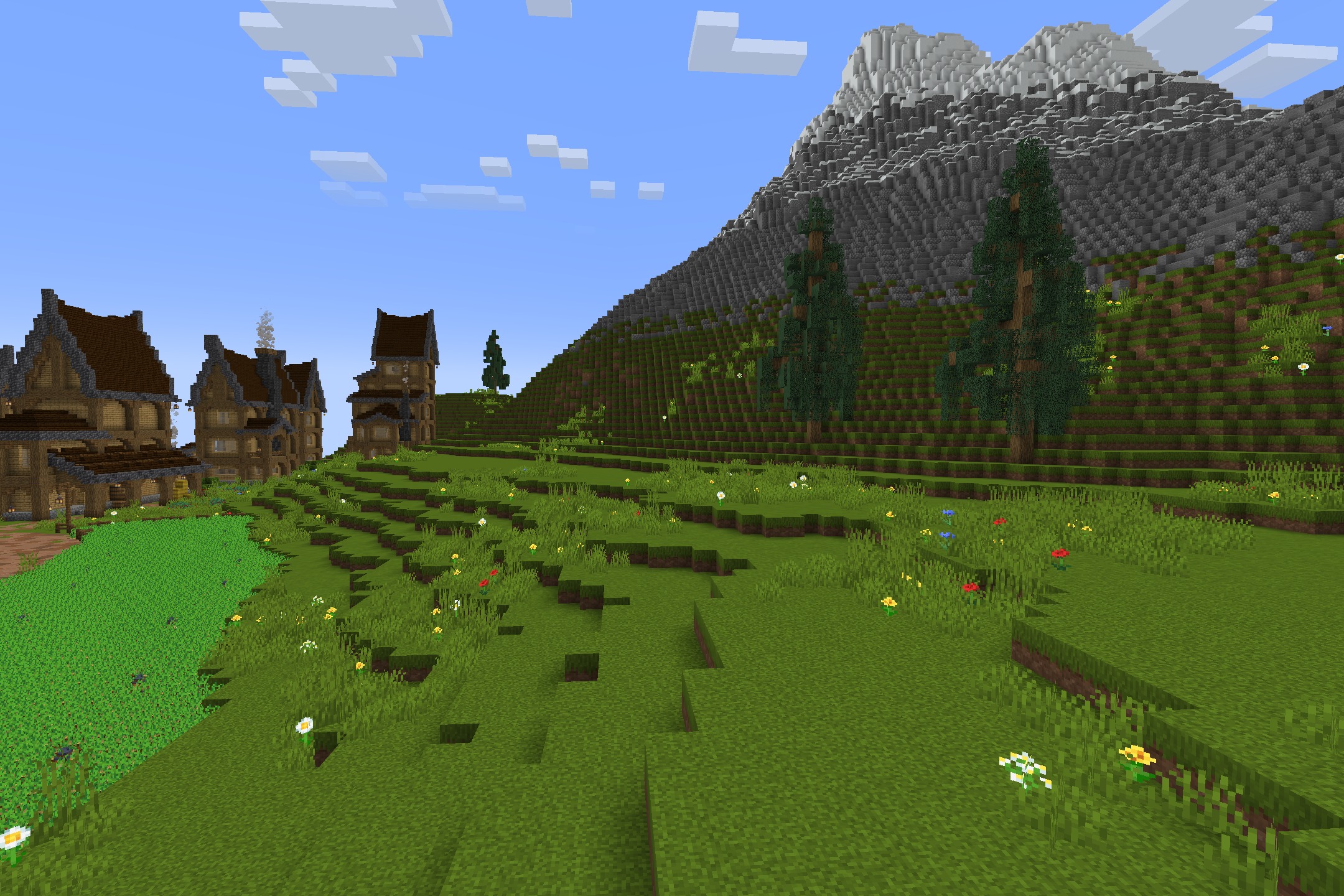 Tazko’s Fresh Textures Resource Pack Screenshot 4 Vibrant green landscape with detailed houses and a large mountain in the background