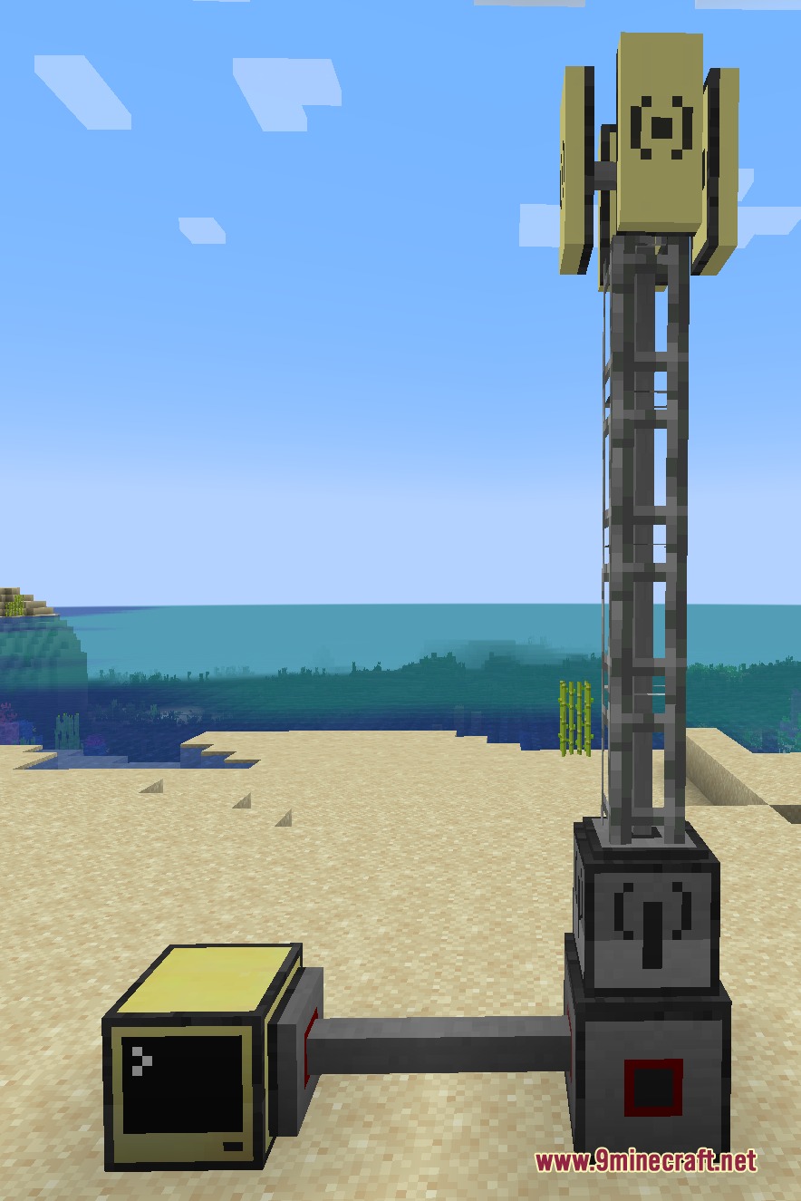 A tall radio tower structure connected to a computer terminal on a beach
